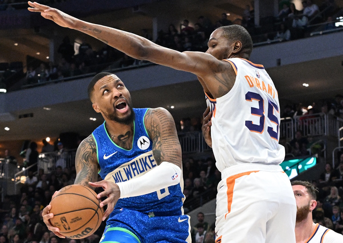 Mar 17, 2024; Milwaukee, Wisconsin, USA; Milwaukee Bucks guard Damian Lillard (0) drives to the basket against Phoenix Suns forward Kevin Durant (35) int he first half at Fiserv Forum. Mandatory Credit: Michael McLoone-USA TODAY Sports