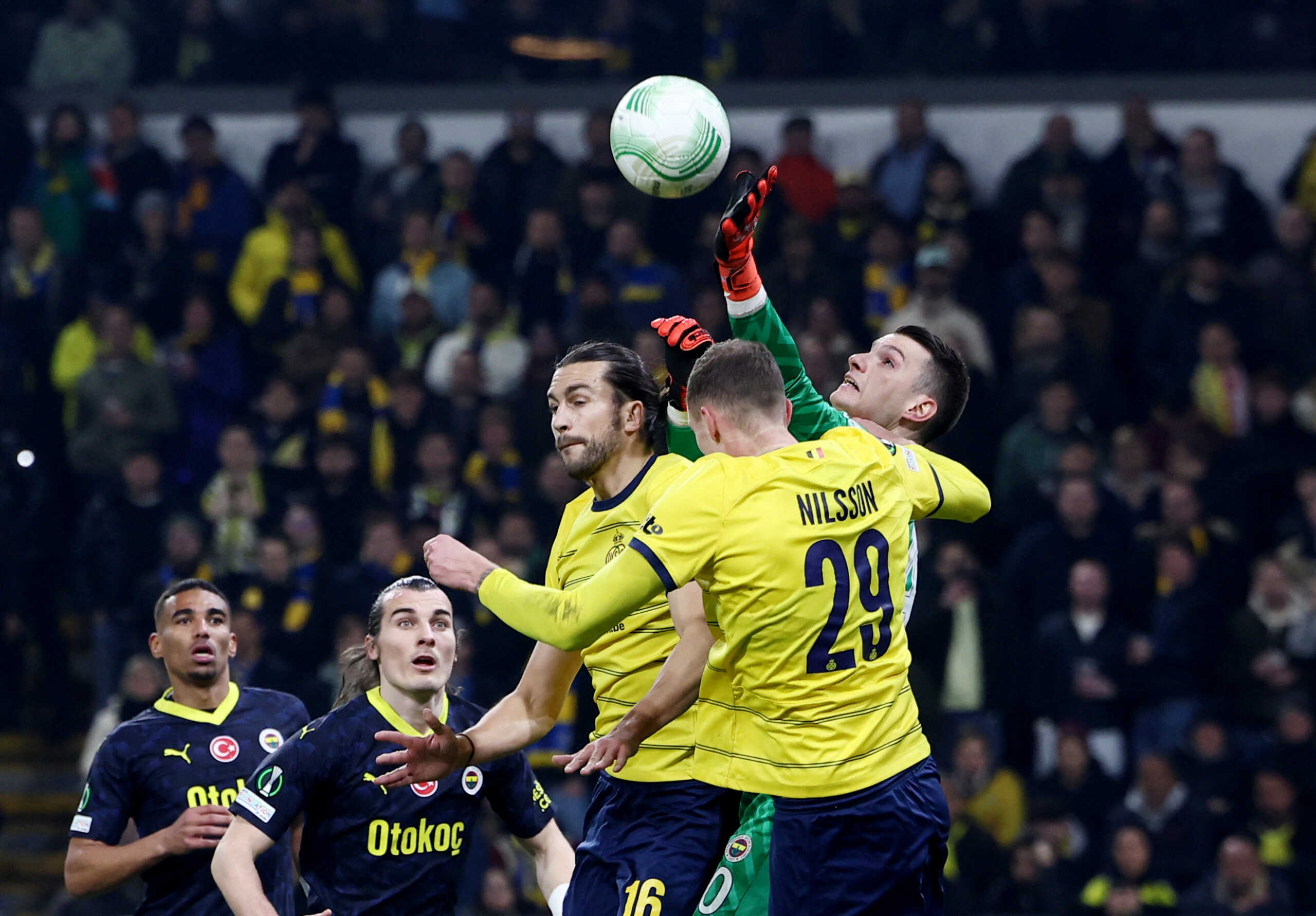Soccer Football - Europa Conference League - Round of 16 - First Leg - Union Saint-Gilloise v Fenerbahce - Lotto Park, Anderlecht, Belgium - March 7, 2024 Fenerbahce's Dominik Livakovic in action with Union Saint-Gilloise's Gustaf Nilsson REUTERS
