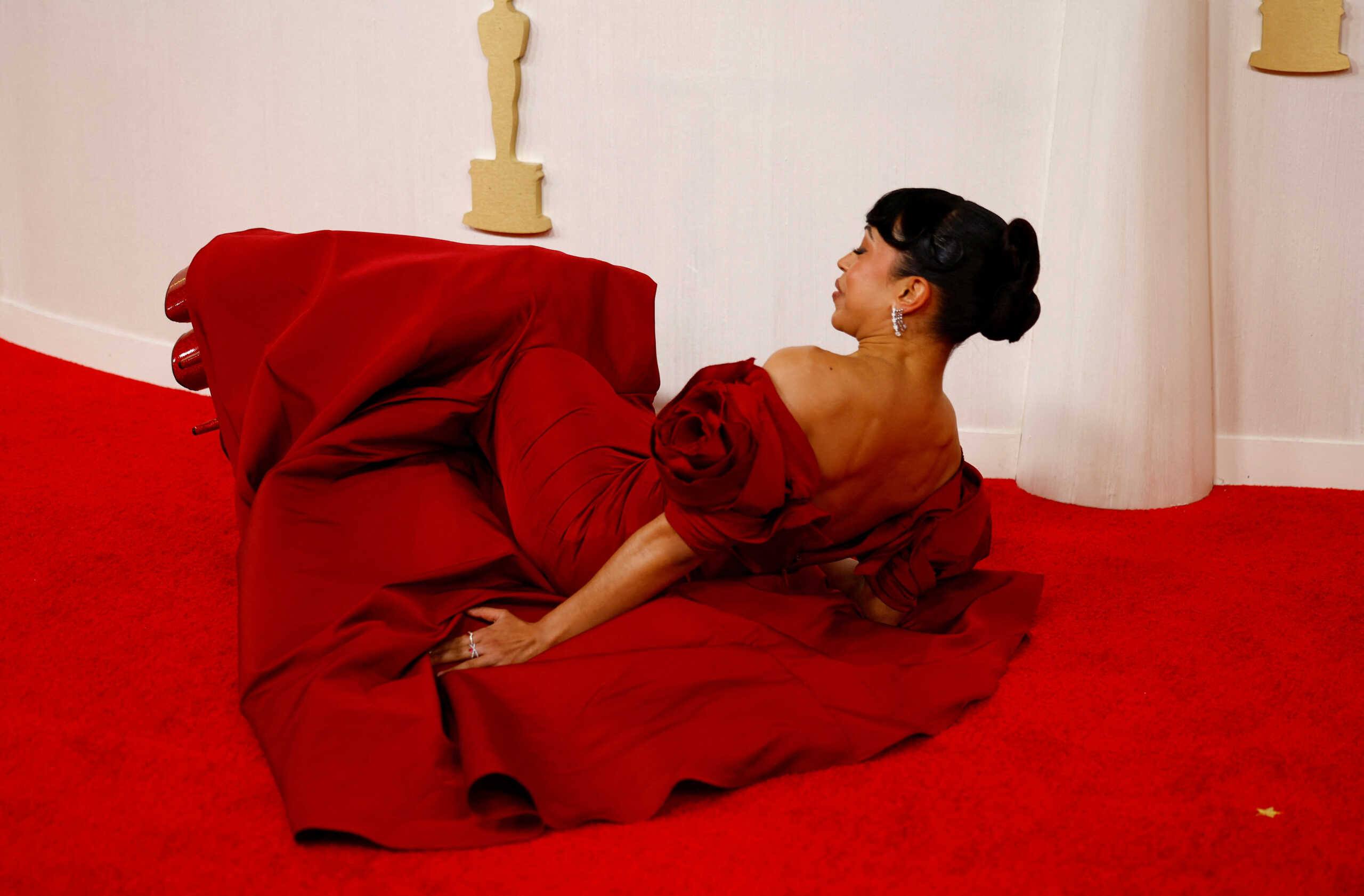 Liza Koshy lies on the ground on the red carpet during the Oscars arrivals at the 96th Academy Awards in Hollywood, Los Angeles, California, U.S., March 10, 2024. REUTERS