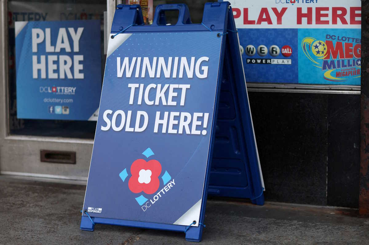 FILE PHOTO: Lottery ticket signs advertising the Mega Millions and Powerball games can be seen in Washington, U.S., July 17, 2023. REUTERS