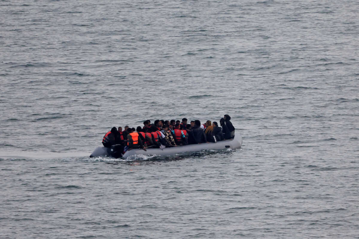 FILE PHOTO: A group of migrants on an inflatable dinghy is seen from the French rescue vessel "Abeille Normandie" as they try to cross the English Channel from the coast of northern France, as warm weather and calm seas are favourable for crossings, France, October 2, 2023. REUTERS