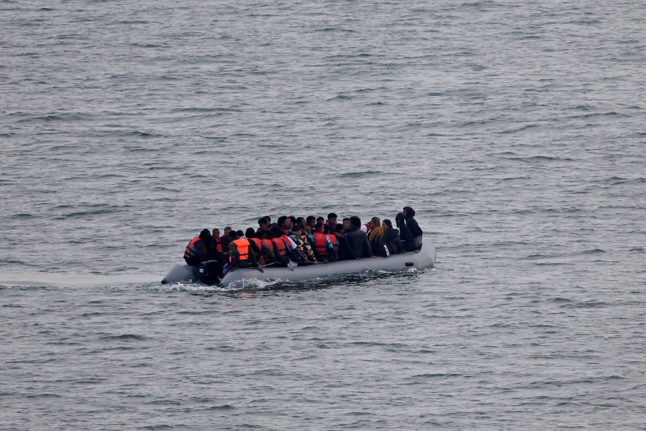 FILE PHOTO: A group of migrants on an inflatable dinghy is seen from the French rescue vessel "Abeille Normandie" as they try to cross the English Channel from the coast of northern France, as warm weather and calm seas are favourable for crossings, France, October 2, 2023. REUTERS