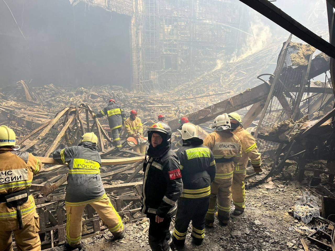 Members of the Russian Emergencies Ministry clear rubble at the Crocus City Hall concert venue after a deadly attack, outside Moscow, Russia, March 23, 2024. Russian Emergencies Ministry