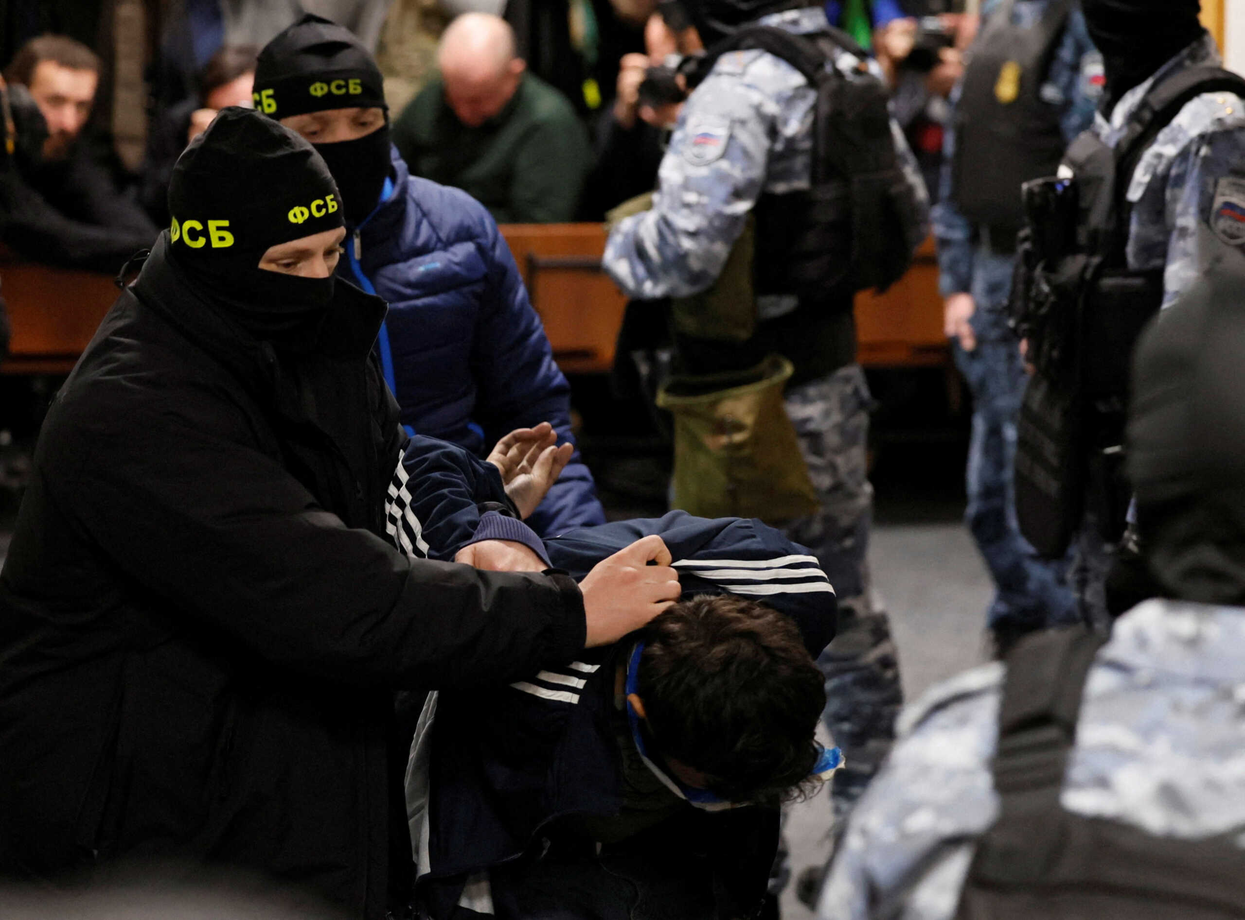 A suspect in the shooting attack at the Crocus City Hall concert venue is escorted inside the Basmanny district court in Moscow, Russia March 24, 2024. REUTERS