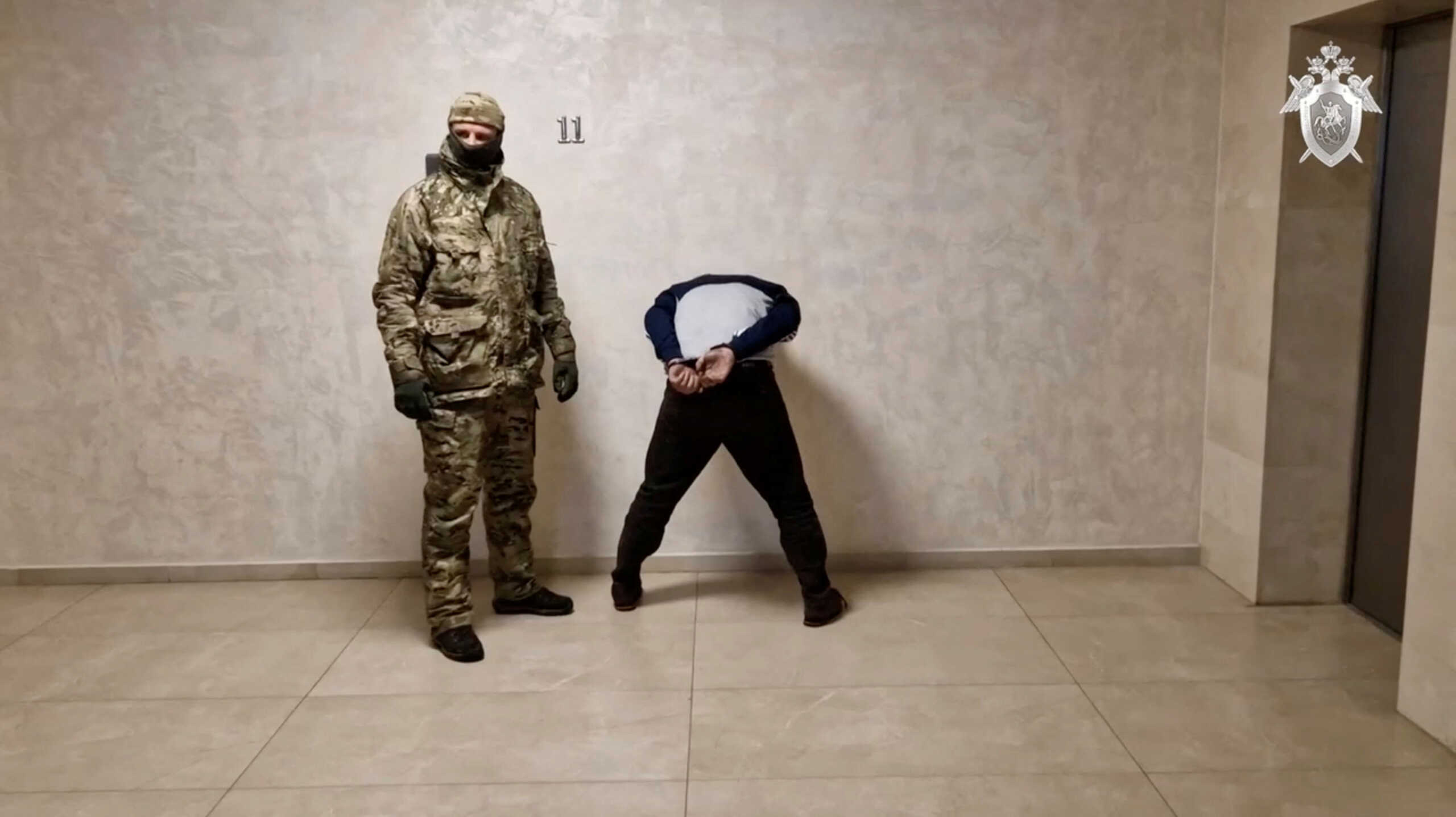 A suspect in the Crocus City Hall shooting is escorted inside the Russian Investigative Committee headquarters in Moscow, Russia, in this still image taken from video released March 24, 2024. Russian Investigative Committee
