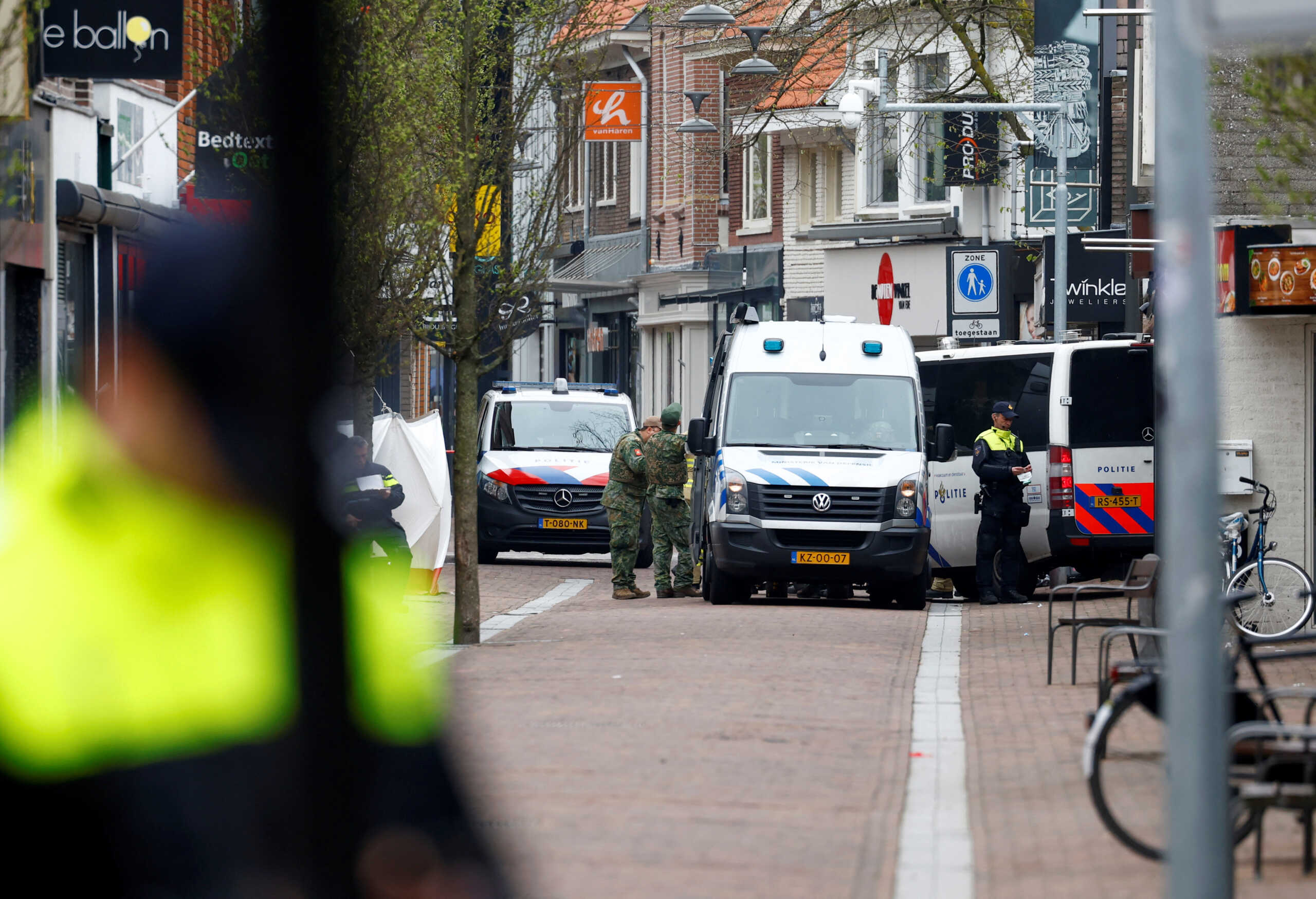 Dutch police officers work near the Cafe Petticoat, where several people are being held hostage in Ede, Netherlands March 30, 2024.  REUTERS