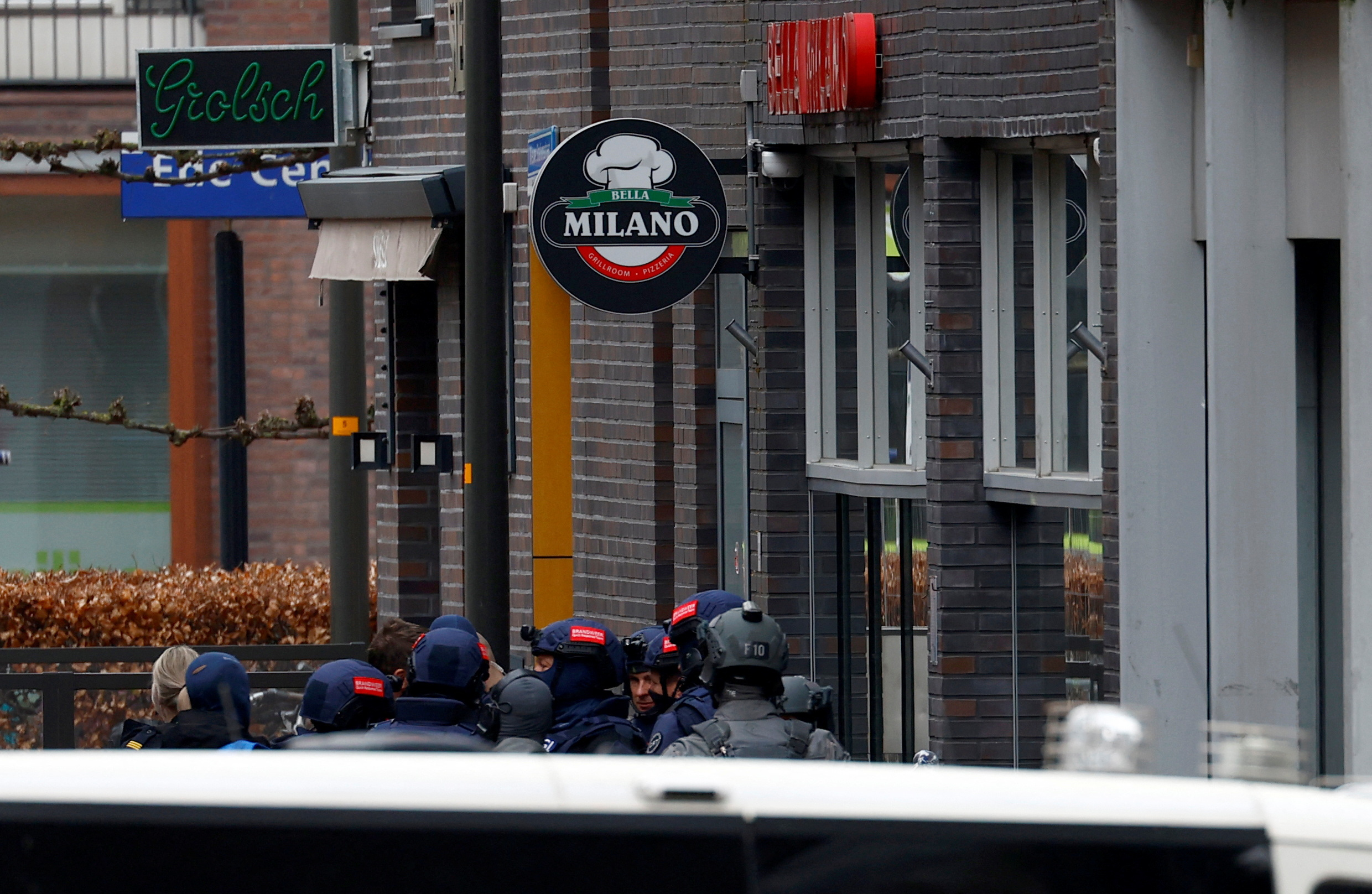 Dutch police officers stand near the Cafe Petticoat, where several people are being held hostage in Ede, Netherlands March 30, 2024.  REUTERS