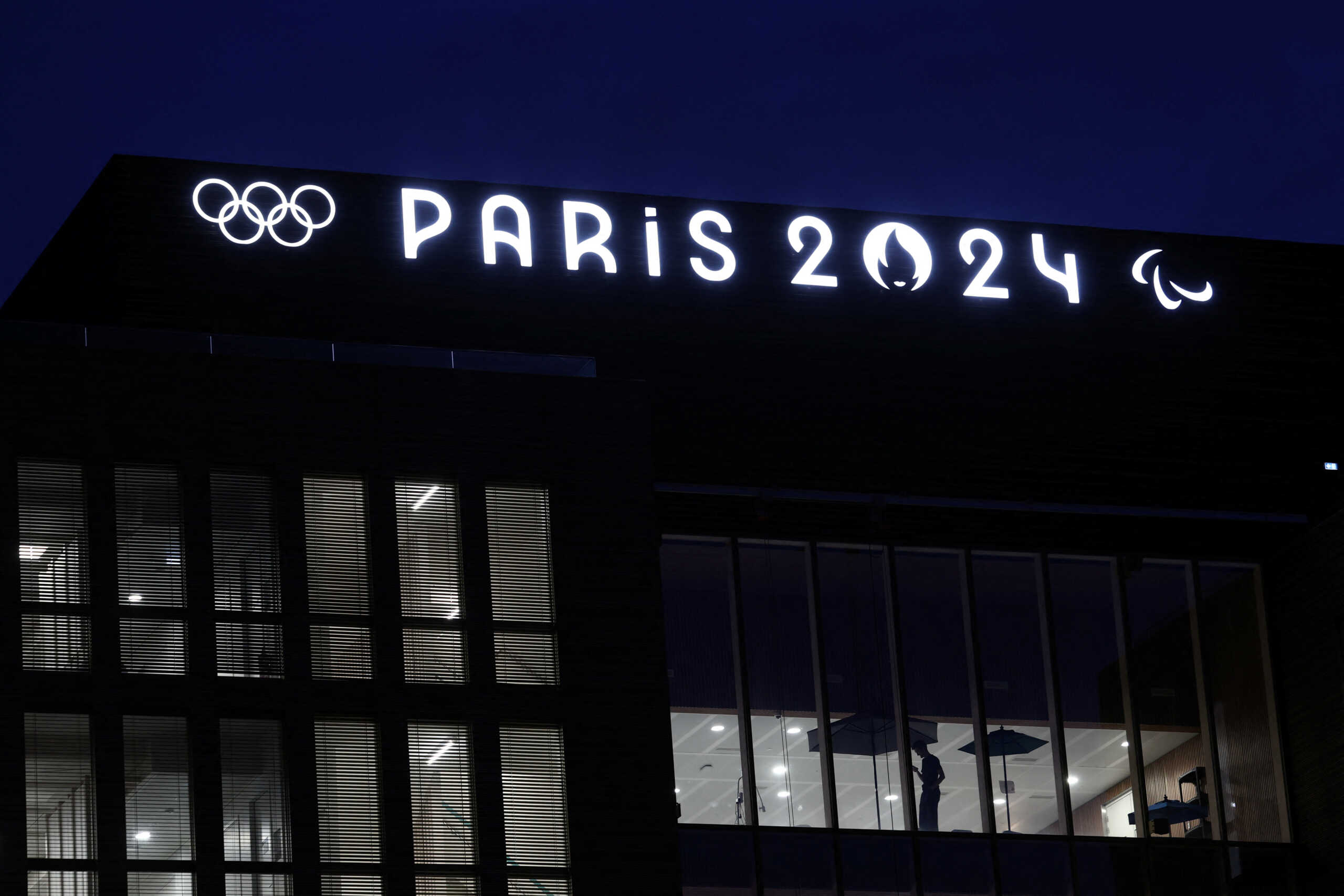The Olympics rings and the logos of the Paris 2024 Olympics and Paralympics Games are pictured on the Pulse building, the headquarters of the Paris 2024 Olympics organizing committee, in Saint-Denis near Paris, France, March 21, 2024. REUTERS