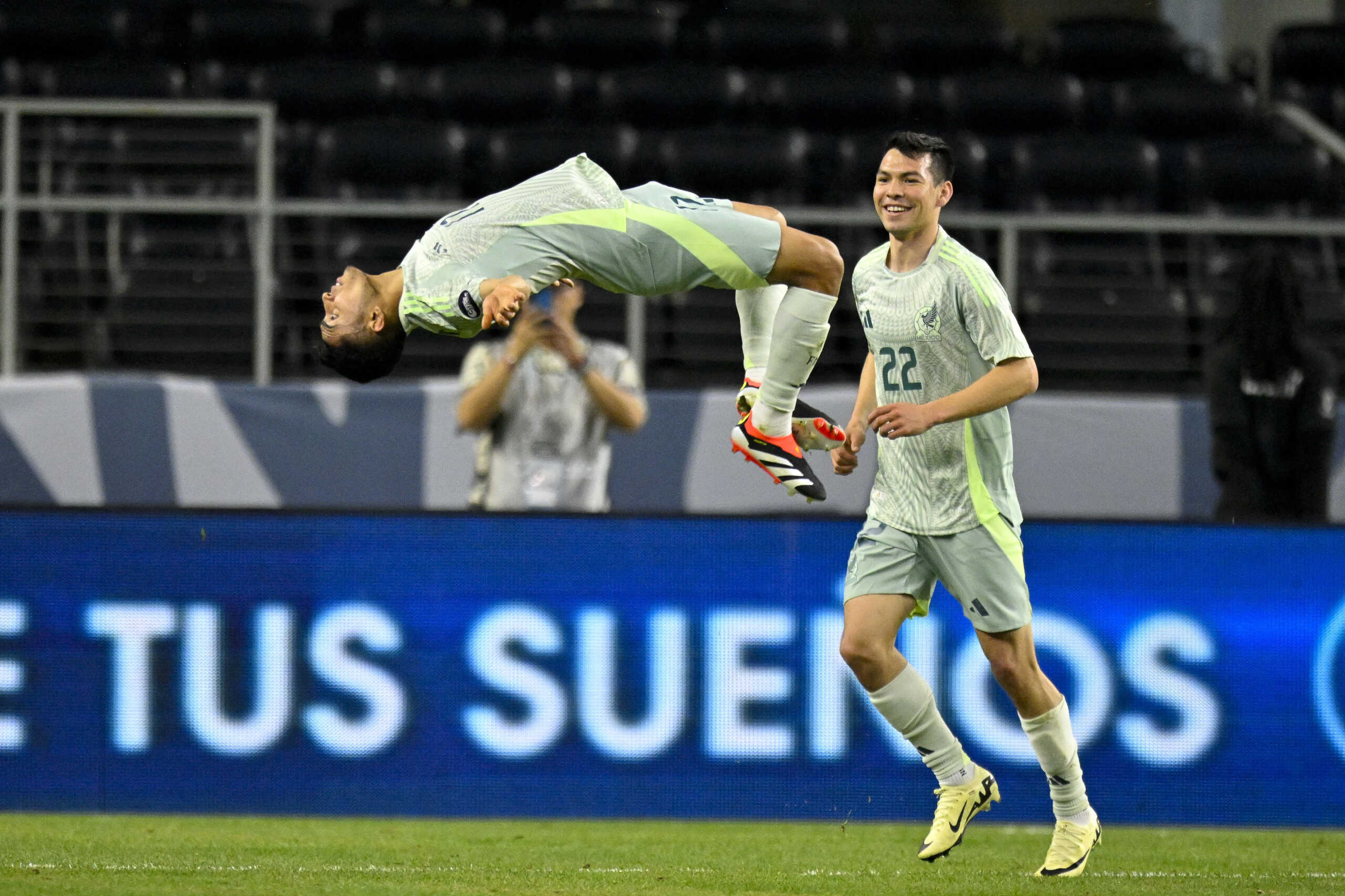 Mar 21, 2024; Arlington, Texas, USA; Mexico midfielder Orbelin Pineda (17) performs a backflip on the field as forward Hirving Lozano (22) looks on after Pineda scores a goal against Panama during the second half at AT&T Stadium. Mandatory Credit: Jerome Miron-USA TODAY Sports