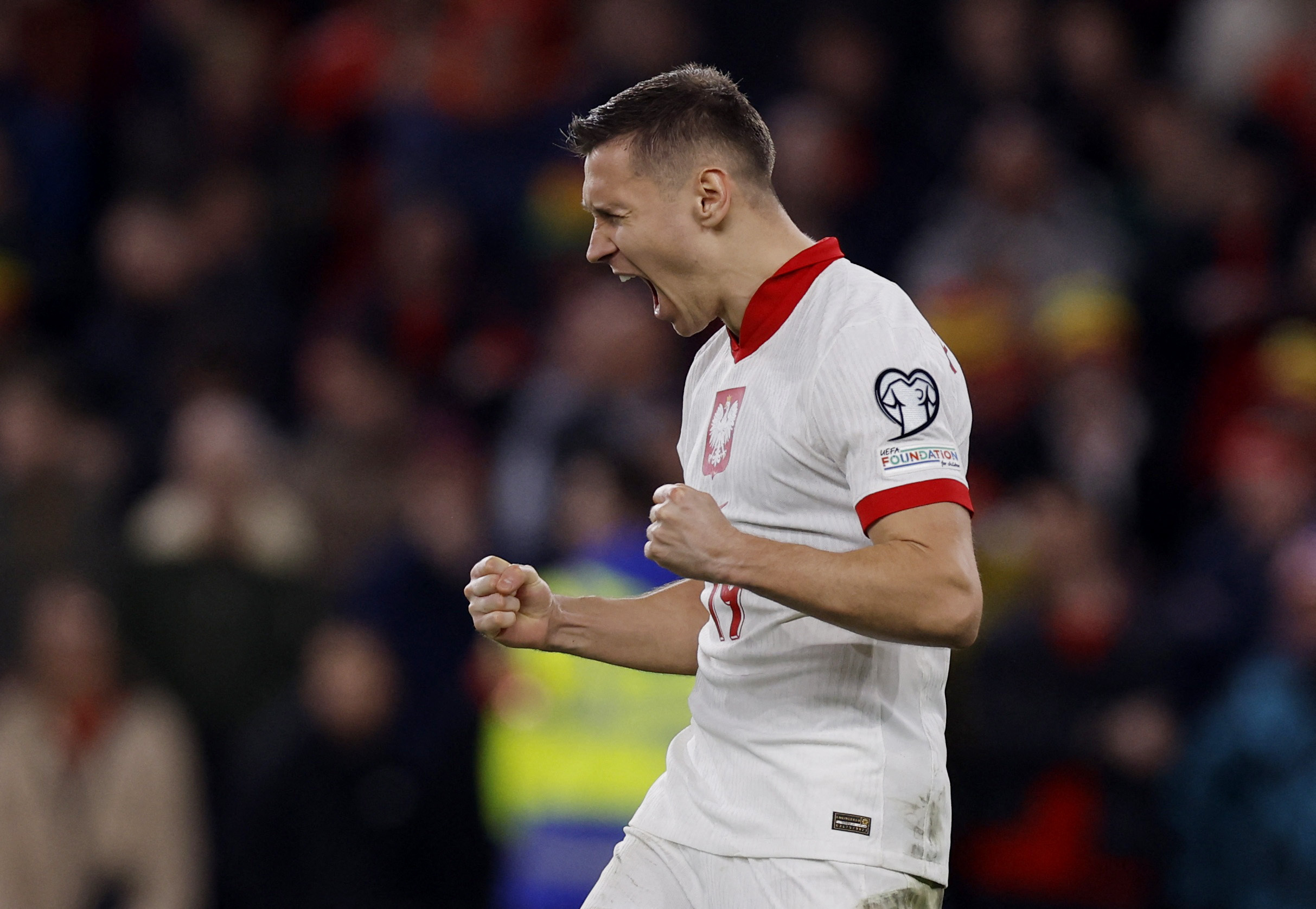 Soccer Football - Euro 2024 Qualifier - Play-Off - Wales v Poland - Cardiff City Stadium, Cardiff, Wales, Britain - March 26, 2024 Poland's Przemyslaw Frankowski celebrates scoring a penalty during a penalty shootout Action Images via Reuters