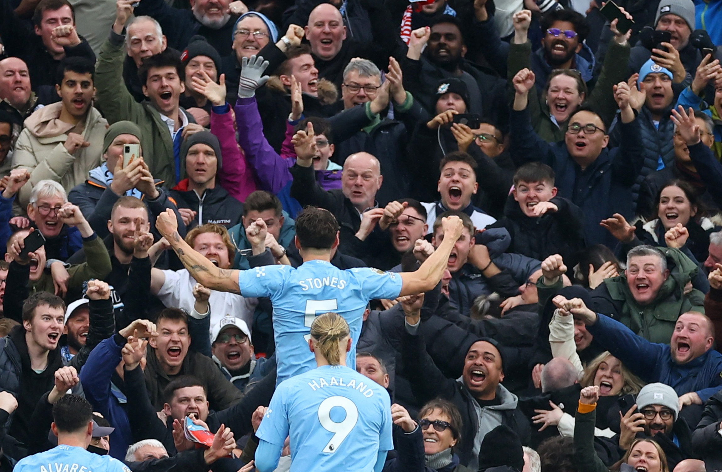 Soccer Football - Premier League - Liverpool v Manchester City - Anfield, Liverpool, Britain - March 10, 2024 Manchester City's John Stones scores their first goal with Erling Braut Haaland as fans react REUTERS