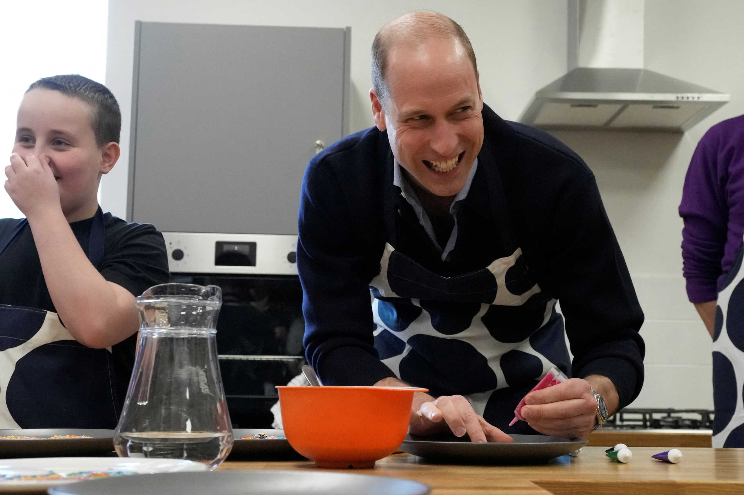 Britain's Prince William smiles as he looks up while decorating biscuits during his visit to WEST, the new OnSide Youth Zone, in Hammersmith and Fulham in London, Britain, March 14, 2024. Frank Augstein