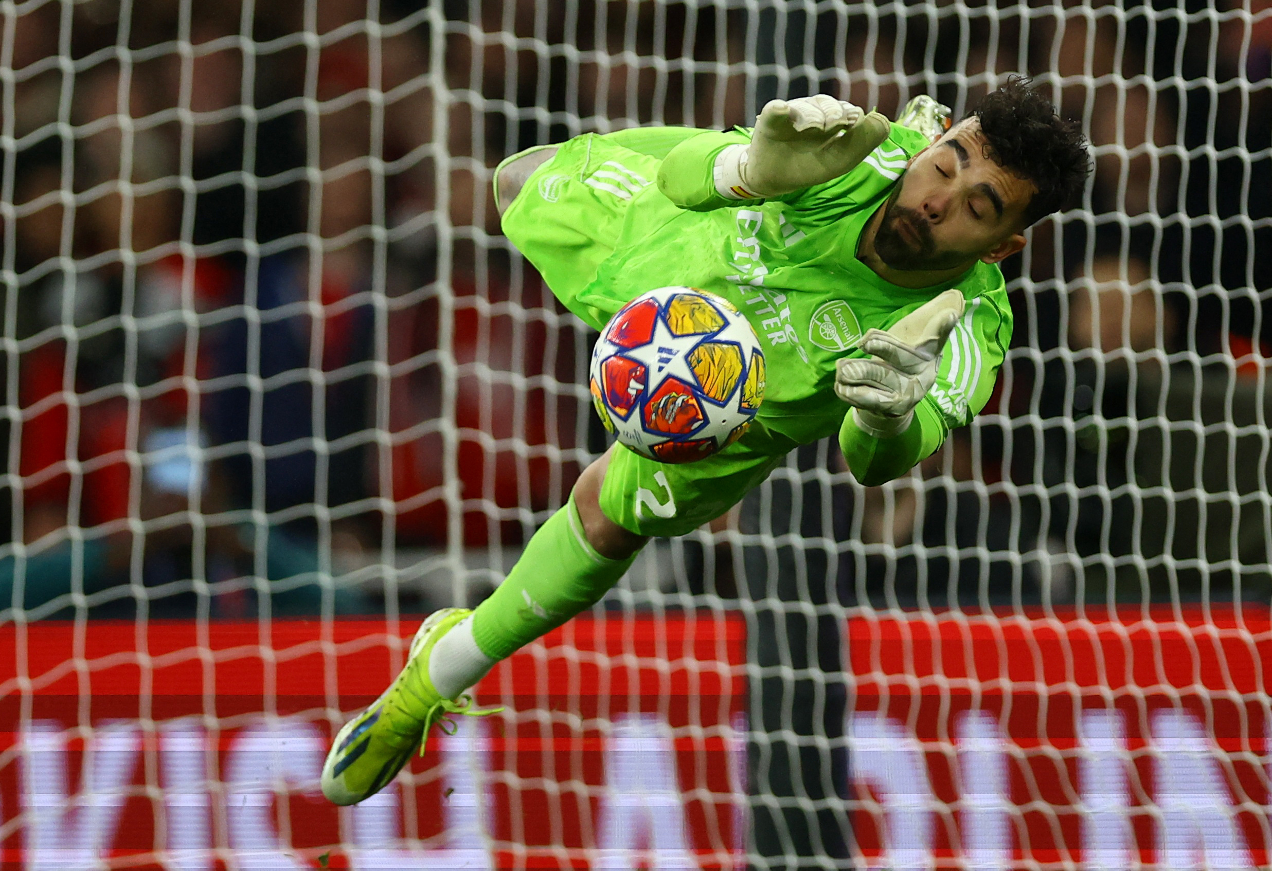 Soccer Football - Champions League - Round of 16 - Second Leg - Arsenal v FC Porto - Emirates Stadium, London, Britain - March 12, 2024 Arsenal's David Raya saves from FC Porto's Galeno to win the penalty shoot-out REUTERS