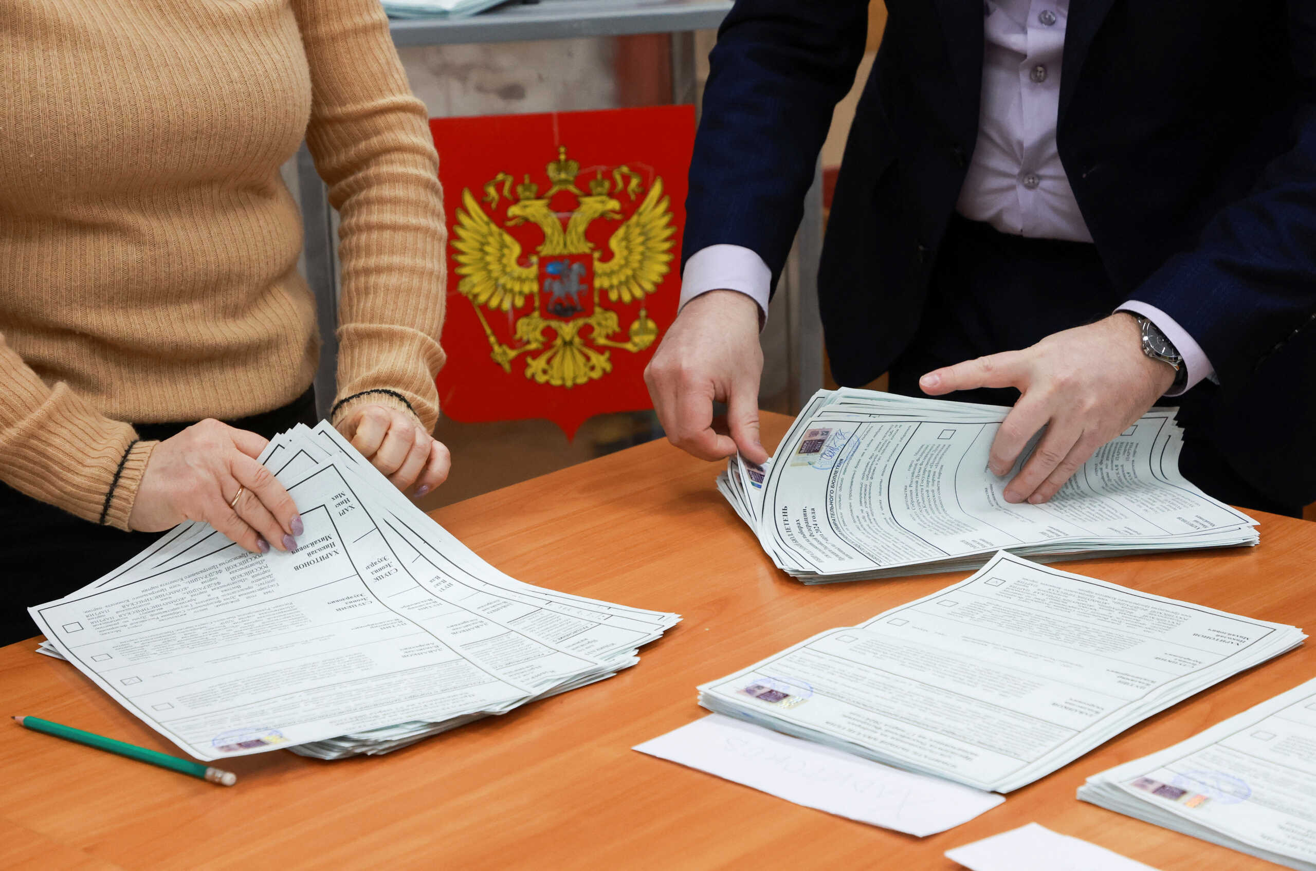 Members of an electoral commission count votes, after polling stations closed on the final day of the presidential election in Saint Petersburg, Russia, March 17, 2024. REUTERS