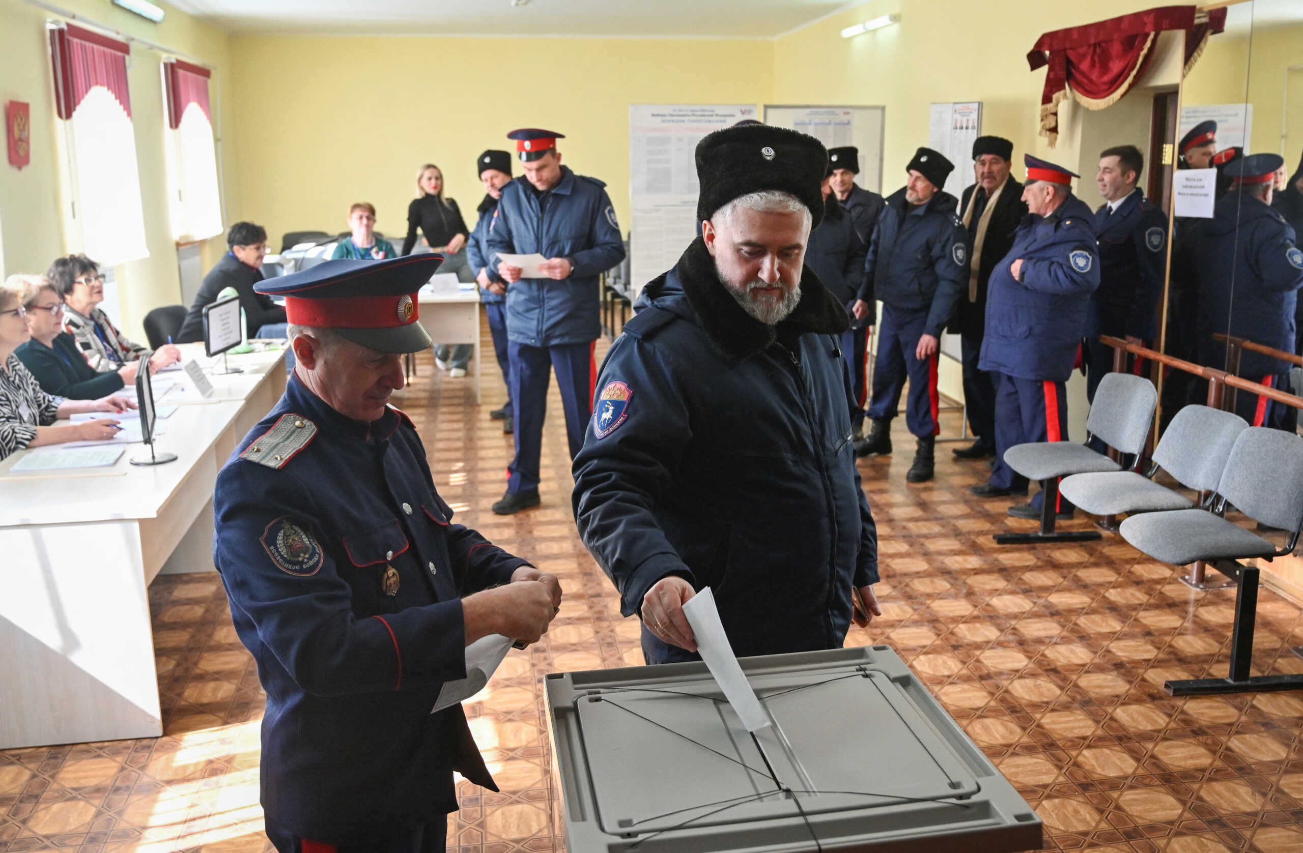 Cossacks vote at a polling station on the second day of a three-day long presidential election in the settlement of Krasny Kolos in Rostov Region, Russia March 16, 2024.  REUTERS