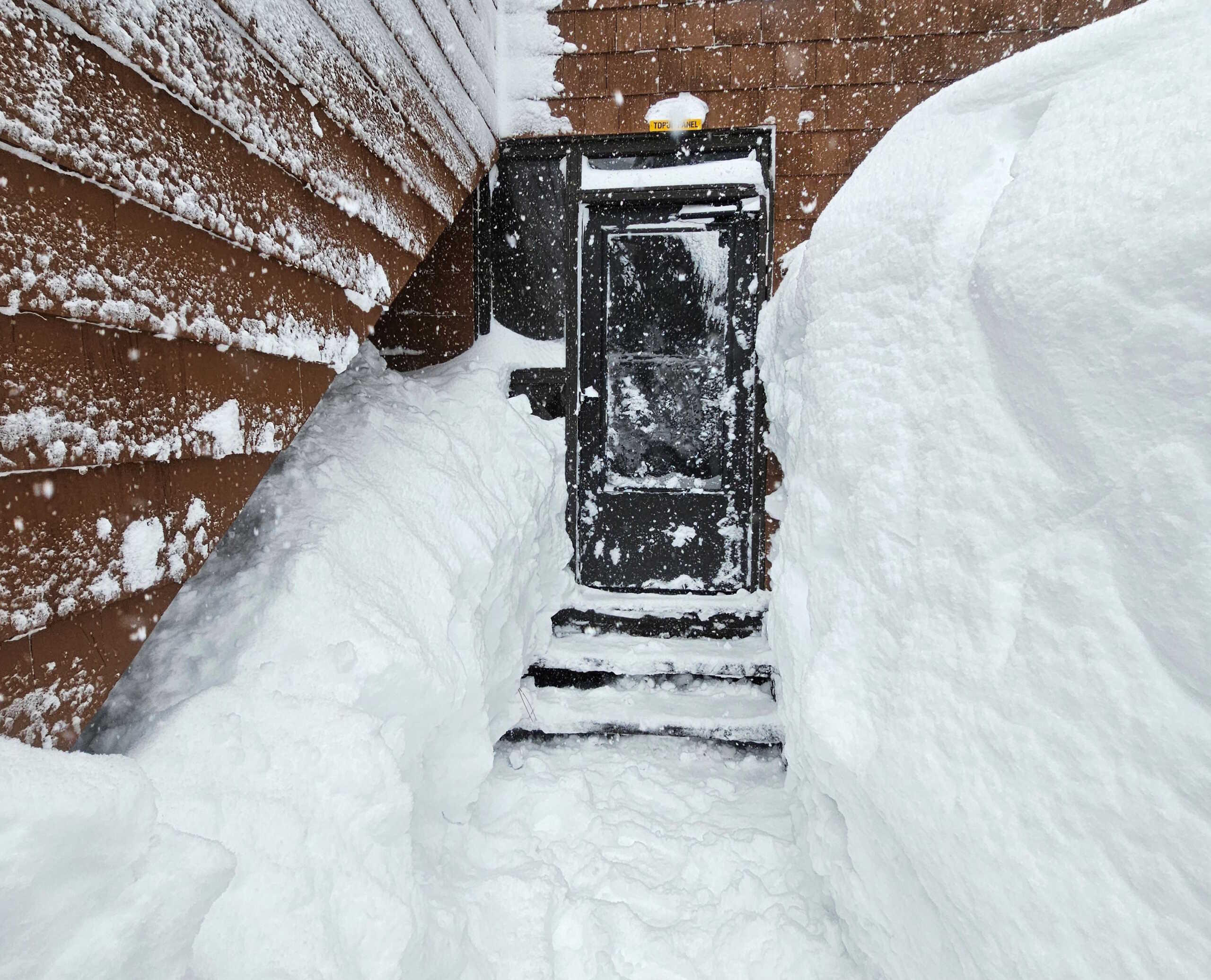 A house's entrance is covered with snow, in Truckee, U.S., in this picture obtained from social media, Marcg 2, 2024 . Ashley Belline