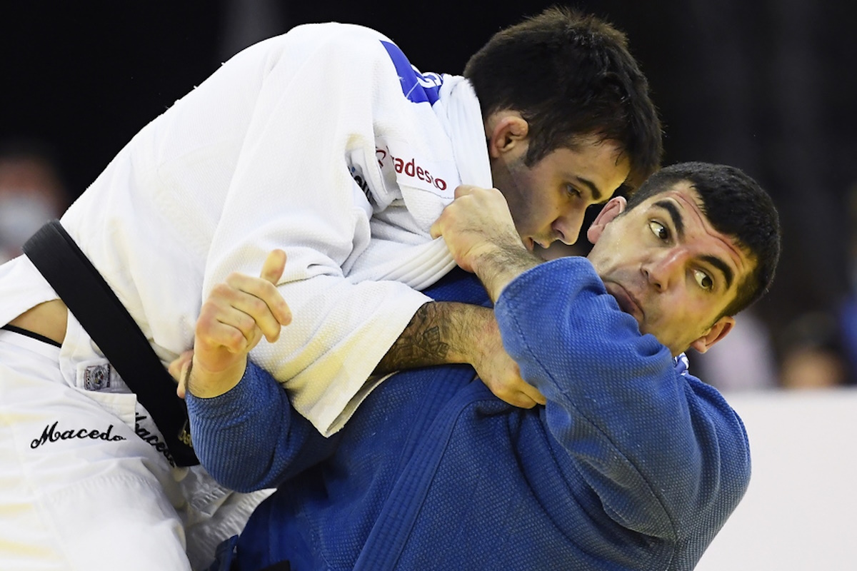 epa08773572 Rafael Macedo (white) of Brazil in action against Theodoros Tselidis (blue) of Greece during their men's -90kg category bout of the Judo Grand Slam at Papp Laszlo Budapest Sports Arena in Budapest, Hungary, 25 October 2020.  EPA