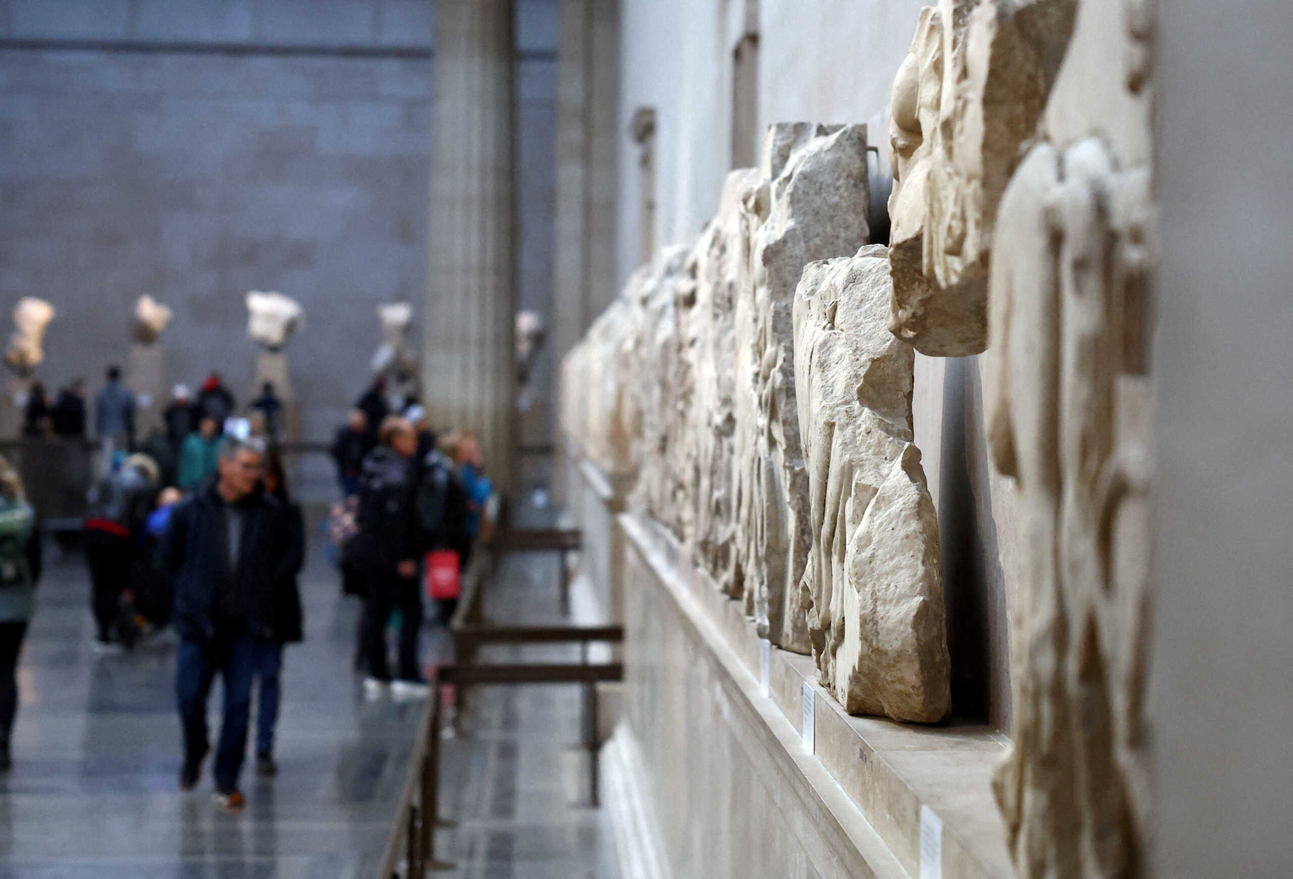 FILE PHOTO: People view examples of the Parthenon sculptures, sometimes referred to in the UK as the Elgin Marbles, on display at the British Museum in London, Britain, November 29, 2023. REUTERS