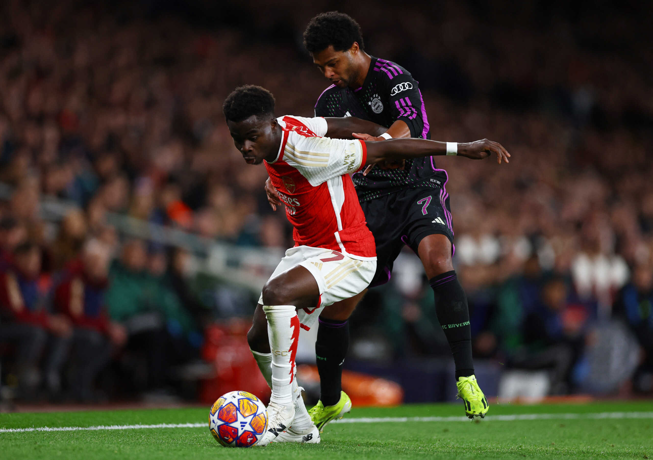 Soccer Football - Champions League - Quarter Final - First Leg - Arsenal v Bayern Munich - Emirates Stadium, London, Britain - April 9, 2024 Arsenal's Bukayo Saka in action with Bayern Munich's Serge Gnabry Action Images via Reuters