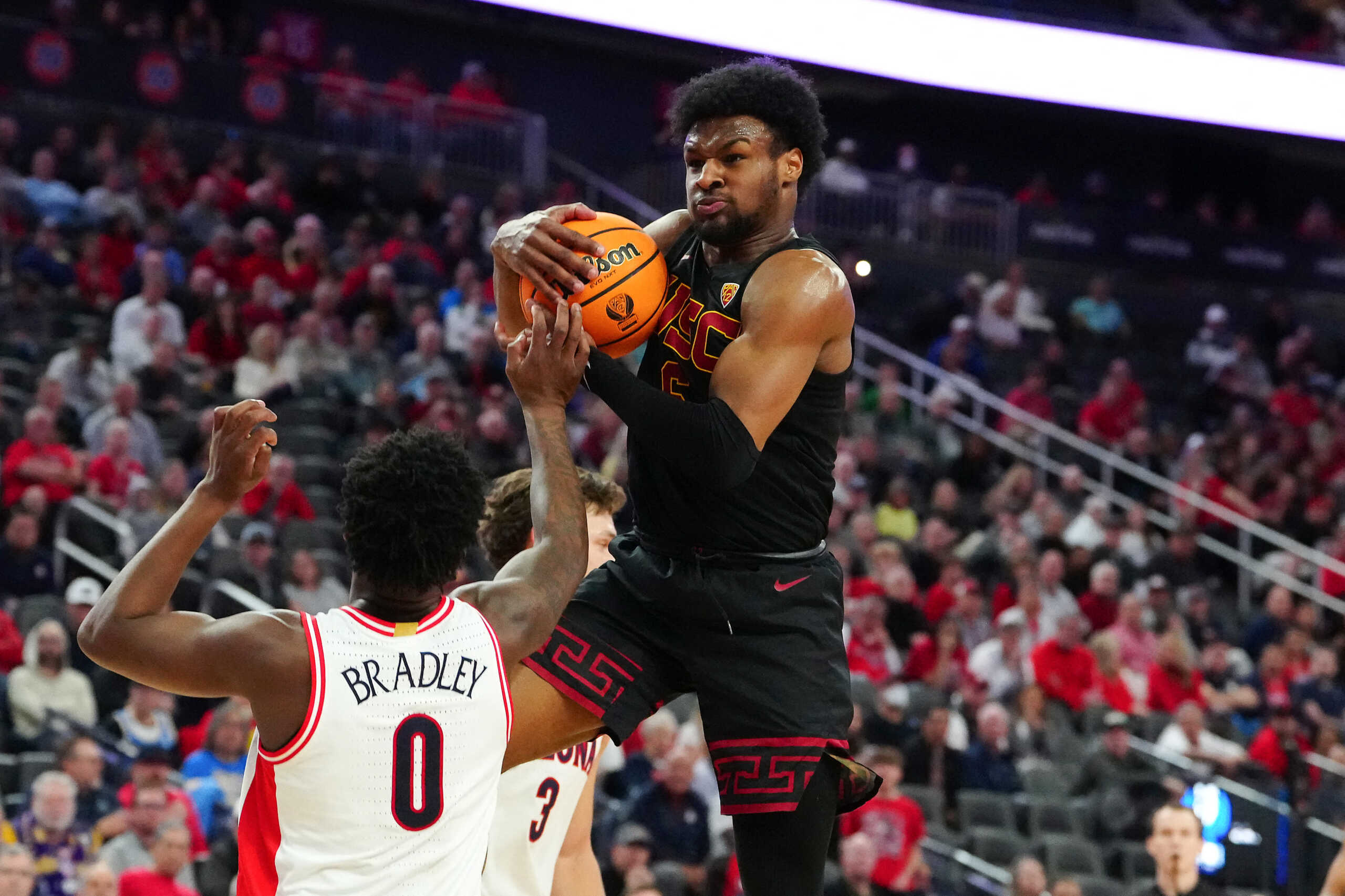 Mar 14, 2024; Las Vegas, NV, USA; Southern California Trojans guard Bronny James (6) pulls down a defensive rebound from Arizona Wildcats guard Jaden Bradley (0) during the first half at T-Mobile Arena. Mandatory Credit: Stephen R. Sylvanie-USA TODAY Sports
