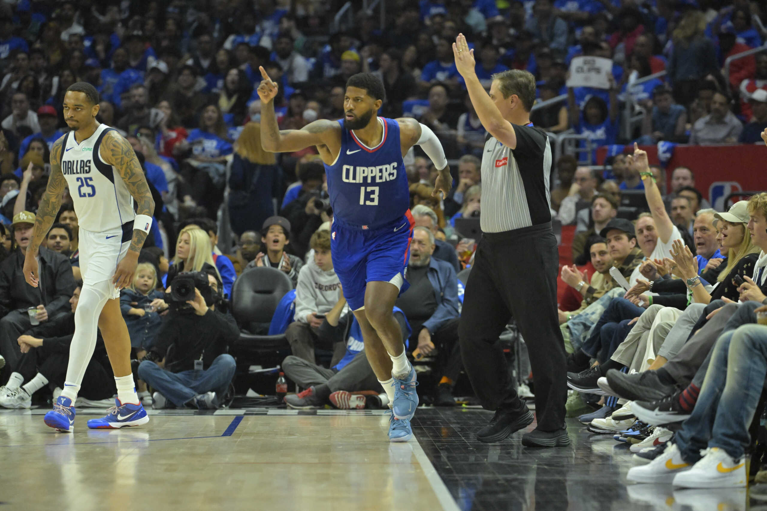 Apr 21, 2024; Los Angeles, California, USA; Los Angeles Clippers forward Paul George (13) heads down court after a 3-point basket in the second half of game one of the first round for the 2024 NBA playoffs against the Dallas Mavericks at Crypto.com Arena. Mandatory Credit: Jayne Kamin-Oncea-USA TODAY Sports