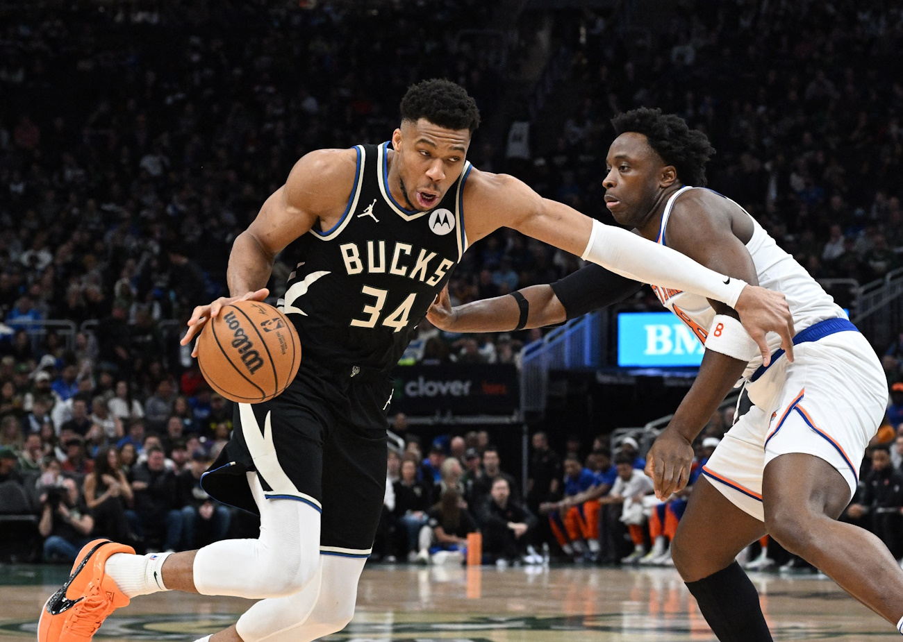 Apr 7, 2024; Milwaukee, Wisconsin, USA; Milwaukee Bucks forward Giannis Antetokounmpo (34) dribbles past New York Knicks forward OG Anunoby (8) in the first half at Fiserv Forum. Mandatory Credit: Michael McLoone-USA TODAY Sports