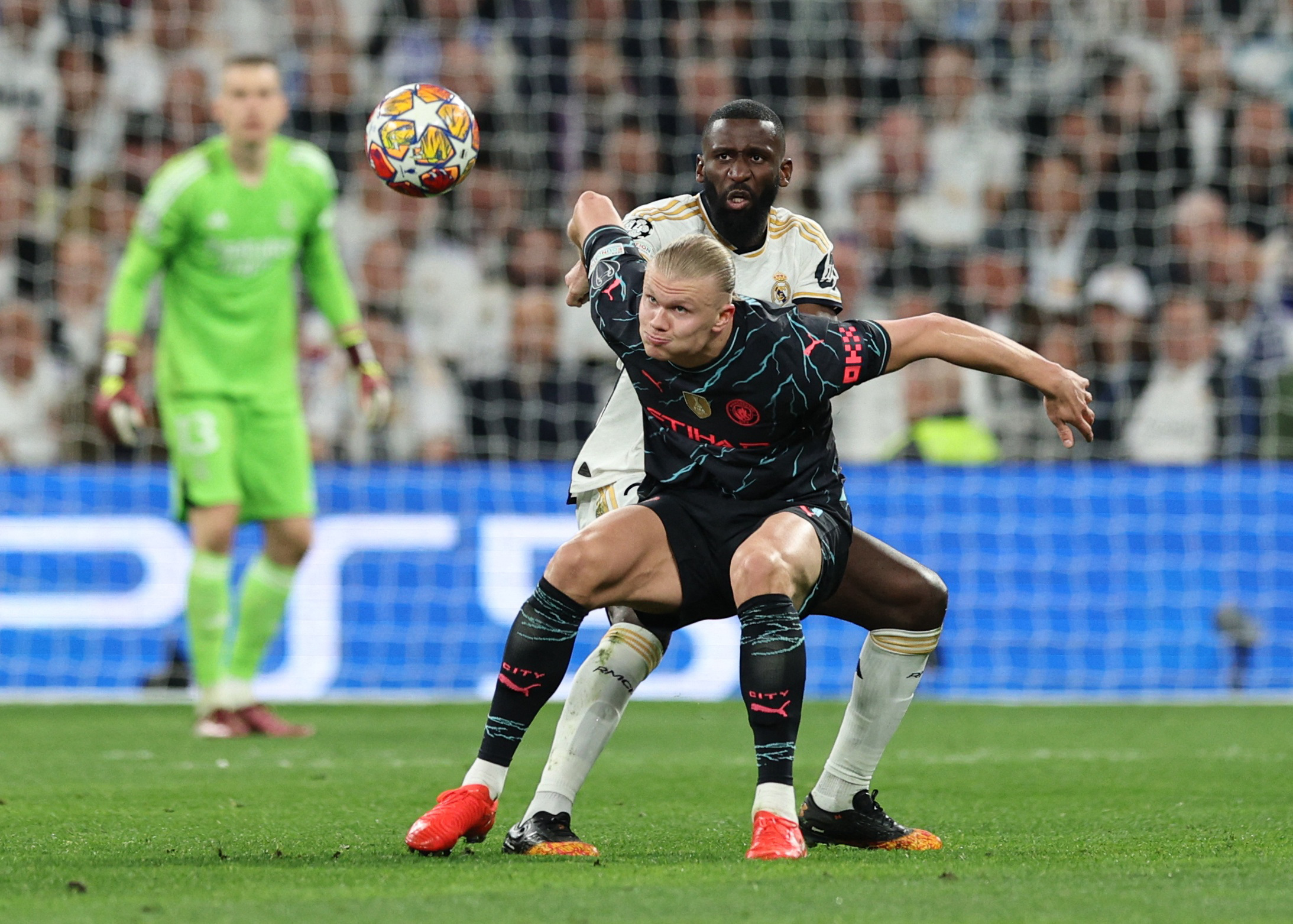 Soccer Football - Champions League - Quarter Final - First Leg - Real Madrid v Manchester City - Santiago Bernabeu, Madrid, Spain - April 9, 2024 Manchester City's Erling Braut Haaland in action with Real Madrid's Antonio Rudiger REUTERS