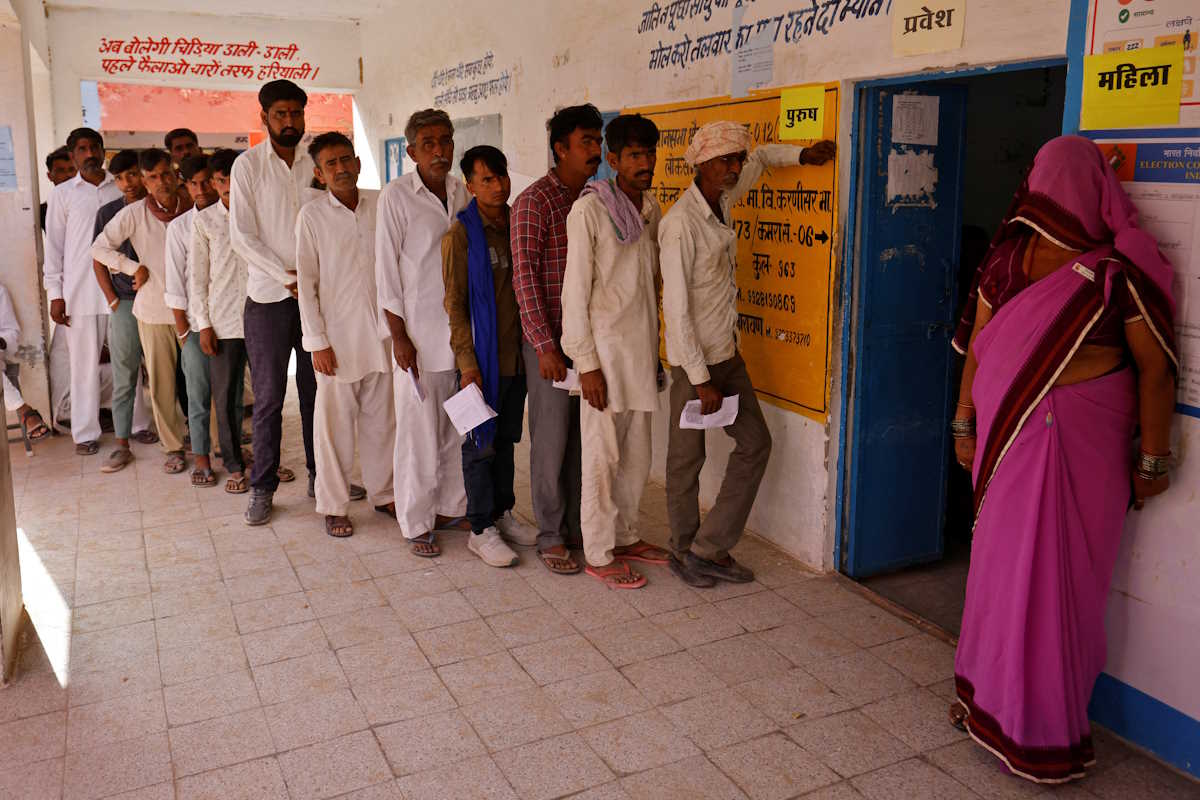 People wait to cast their votes at a polling station during the first phase of the general election, in Bikaner district, Rajasthan, India, April 19, 2024. REUTERS