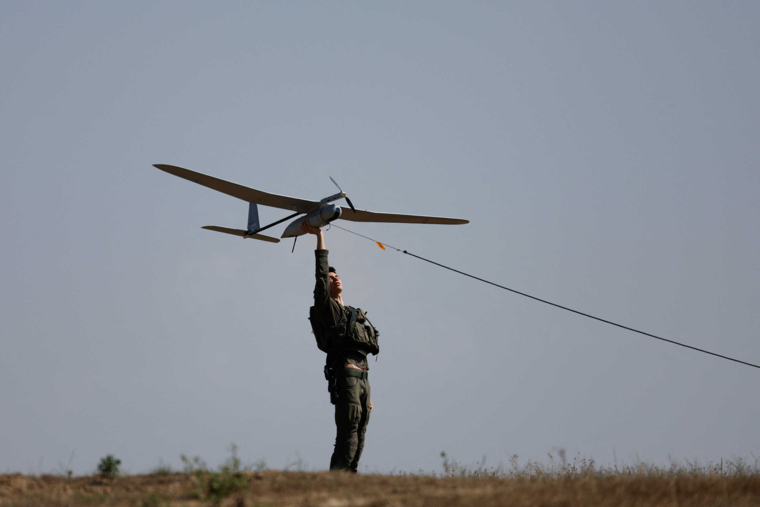 An Israeli soldier flies a drone near the Israel-Gaza border, amid the ongoing conflict between Israel and the Palestinian Islamist group Hamas, in Israel, April 15, 2024. REUTERS