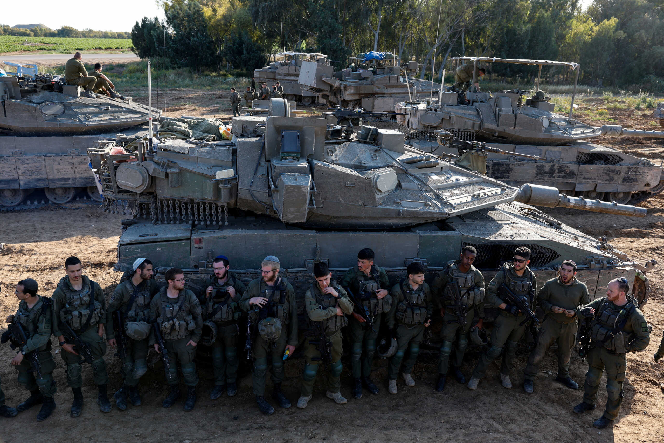 Israeli soldiers listen to a briefing near the Israel-Gaza border, amid the ongoing conflict between Israel and the Palestinian Islamist group Hamas, in Israel, April 10, 2024. REUTERS