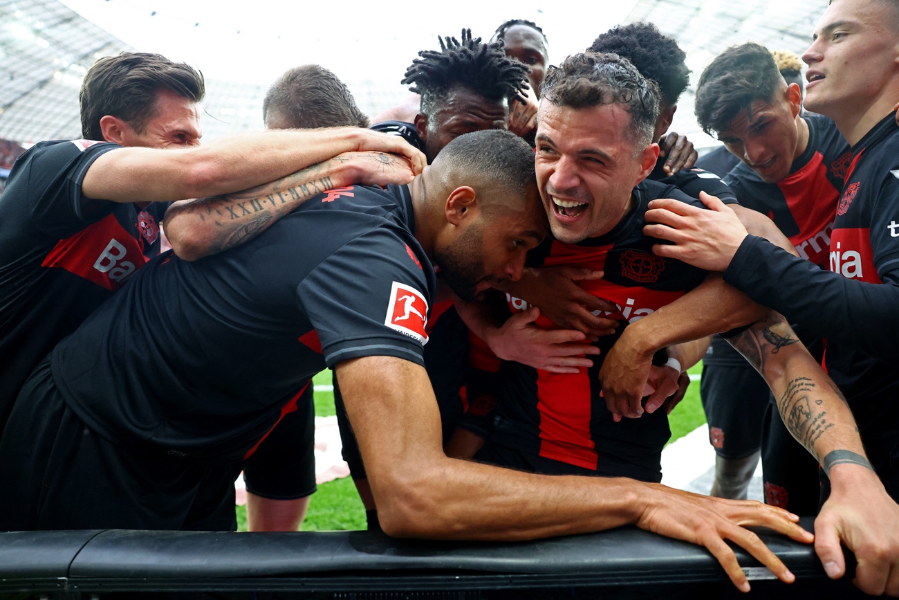 Soccer Football - Bundesliga - Bayer Leverkusen v Werder Bremen - BayArena, Leverkusen, Germany - April 14, 2024 Bayer Leverkusen's Granit Xhaka celebrates scoring their second goal with Jonathan Tah and teammates REUTERS