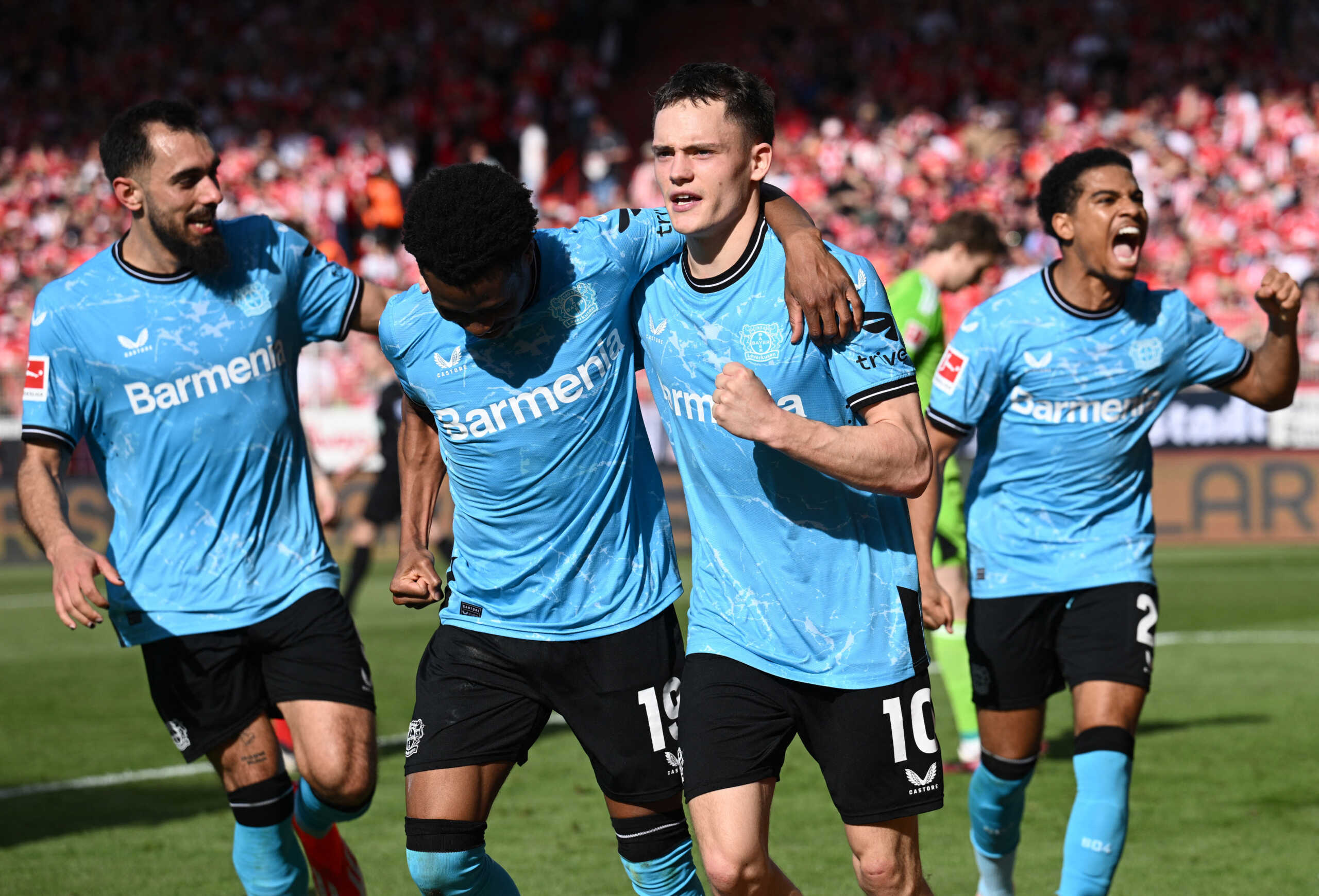 Soccer Football - Bundesliga - 1. FC Union Berlin v Bayer Leverkusen - Stadion An der Alten Forsterei, Berlin, Germany - April 6, 2024 Bayer Leverkusen's Florian Wirtz celebrates scoring their first goal with teammates REUTERS