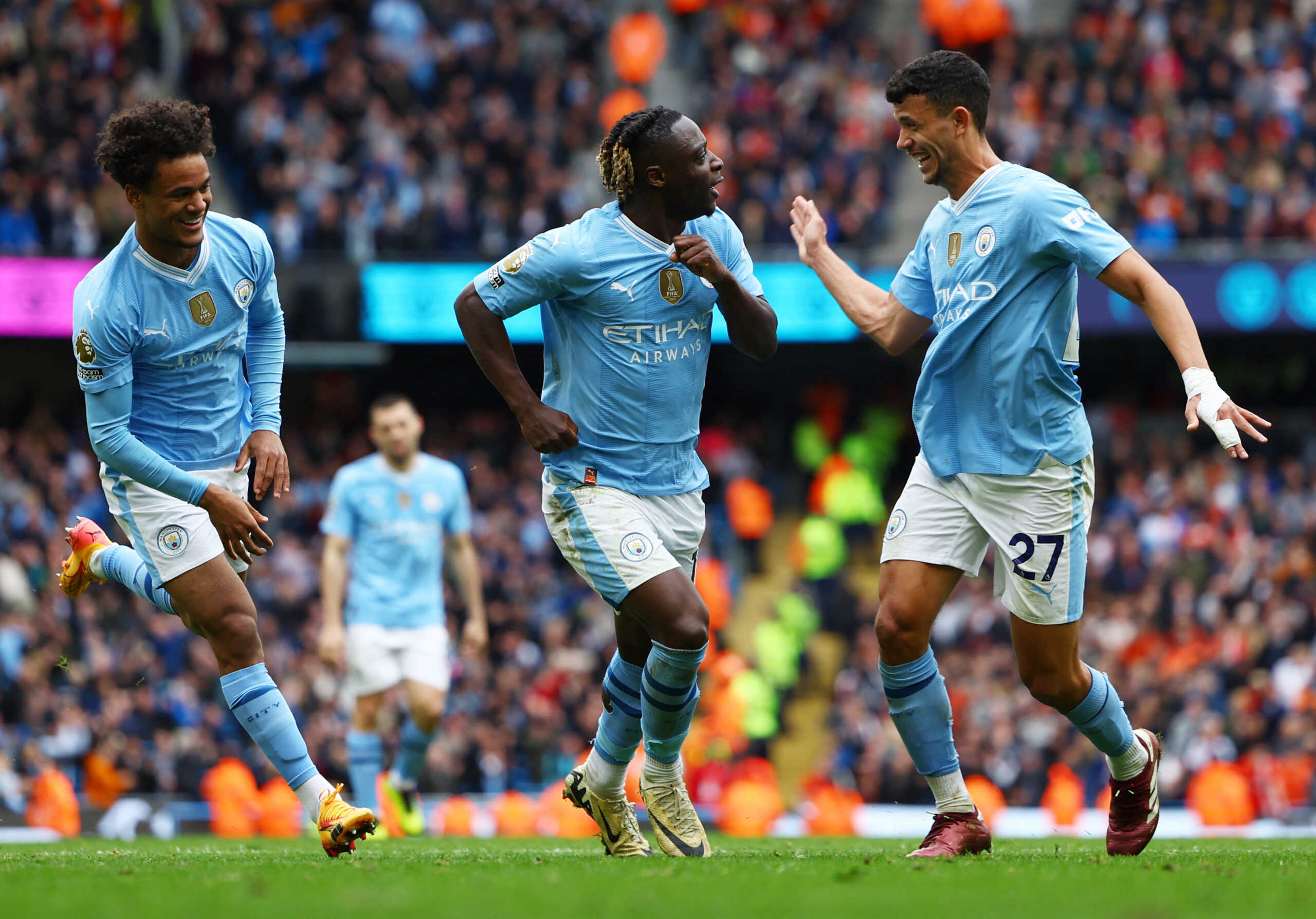 Soccer Football - Premier League - Manchester City v Luton Town - Etihad Stadium, Manchester, Britain - April 13, 2024 Manchester City's Jeremy Doku celebrates scoring their fourth goal with Oscar Bobb and Matheus Nunes REUTERS