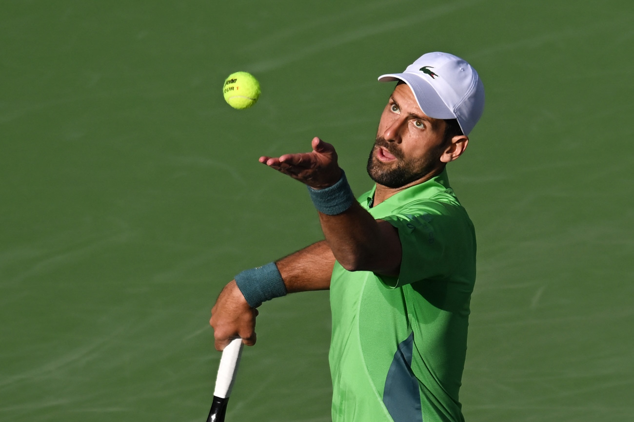 Mar 9, 2024; Indian Wells, CA, USA; Novak Djokovic (SRB) tosses the ball for a serve in his second round match against Aleksandar Vukic (AUS) during the BNP Paribas Open at Indian Wells Tennis Garden. Mandatory Credit: Jonathan Hui-USA TODAY Sports
