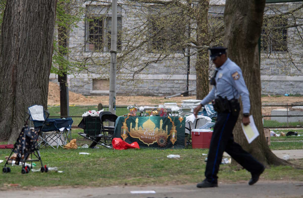 A police officer patrols the area of a shooting that took place during an Eid event being held at Clara Muhammad Square in West Philadelphia, Pennsylvania, U.S., April 10, 2024.  REUTERS