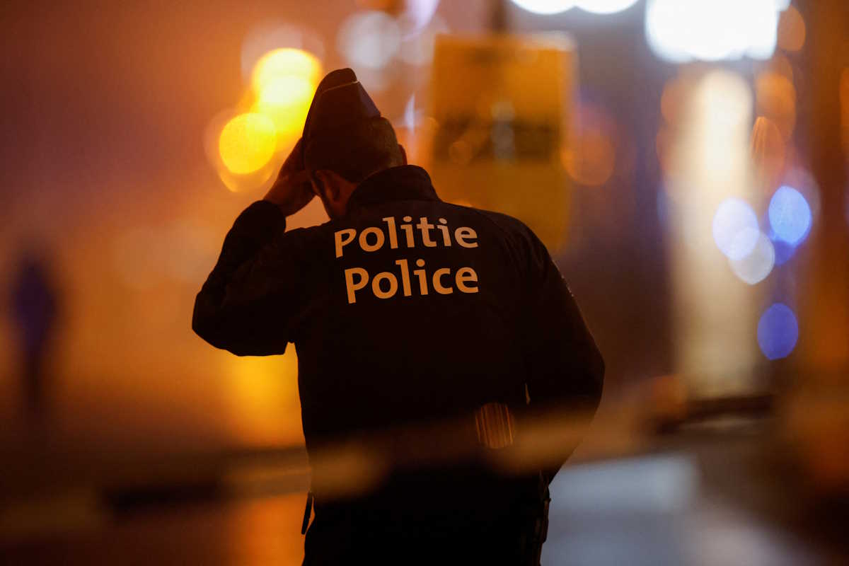 FILE PHOTO: A Belgian police officer stands guard outside the area where, according to police, a shooting took place, injuring several police officers, in Brussels, Belgium, December 6, 2023. REUTERS