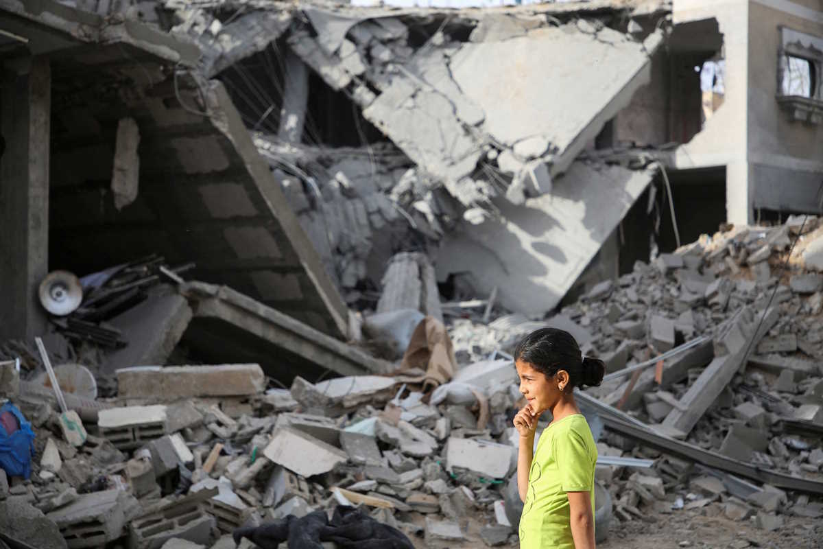 A Palestinian girl walks past the site of an Israeli strike on a house, amid the ongoing conflict between Israel and the Palestinian Islamist group Hamas, in Rafah, in the southern Gaza Strip, April 25, 2024. REUTERS