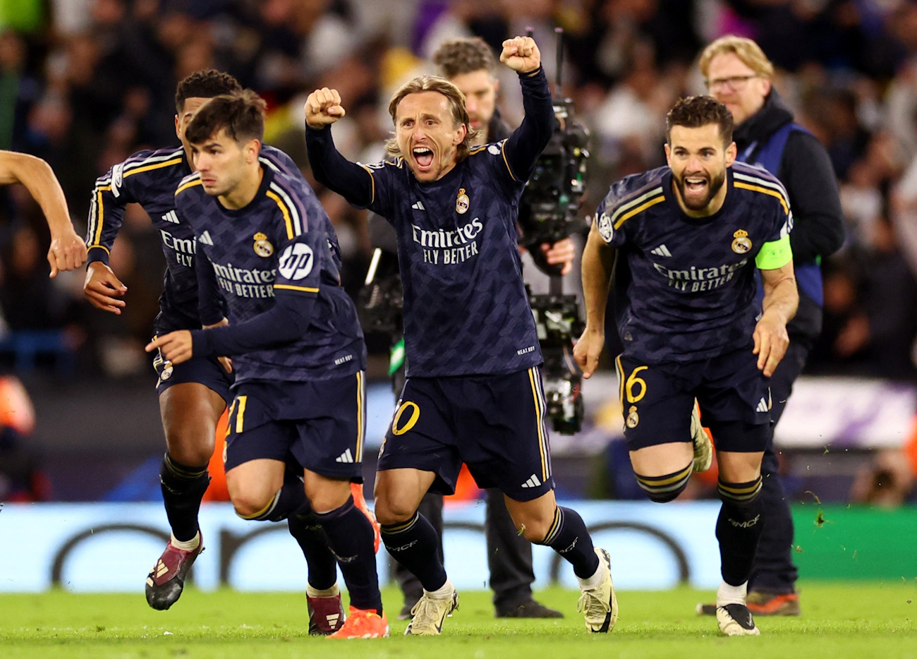 Soccer Football - Champions League - Quarter Final - Second Leg - Manchester City v Real Madrid - Etihad Stadium, Manchester, Britain - April 17, 2024 Real Madrid's Luka Modric and teammates celebrate winning the penalty shootout REUTERS
