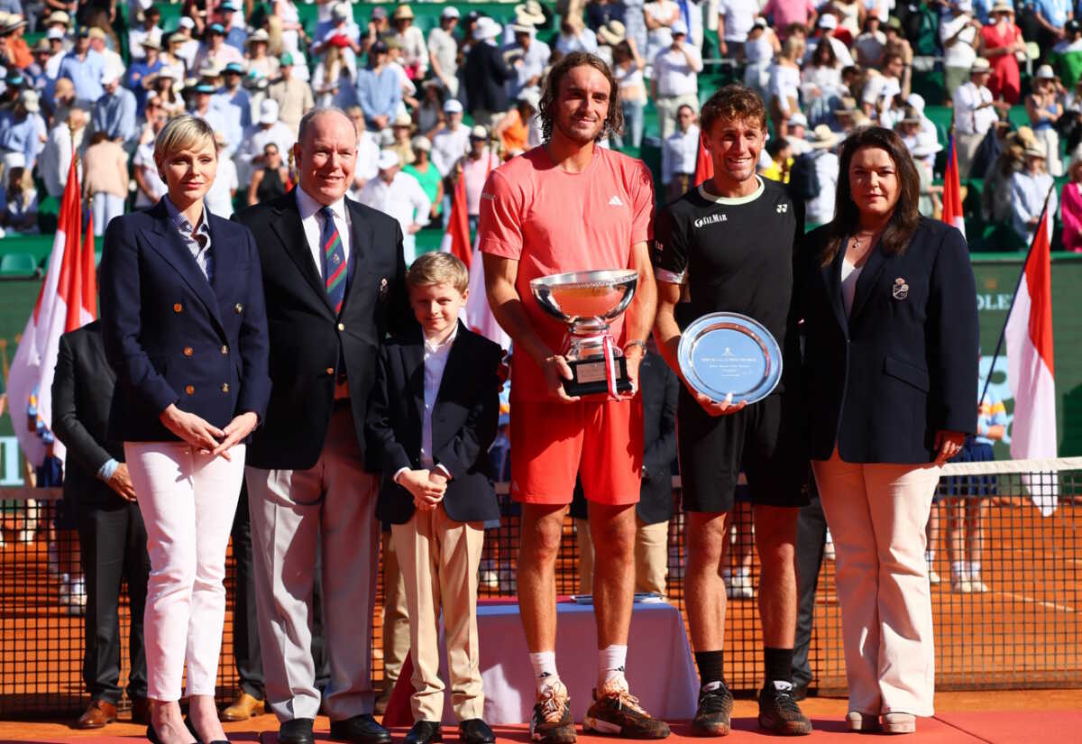 Tennis - ATP Masters 1000 - Monte Carlo Masters - Monte Carlo Country Club, Roquebrune-Cap-Martin, France - April 14, 2024 Greece's Stefanos Tsitsipas celebrates with the trophy after winning his final match against Norway's Casper Ruud with Prince Albert II of Monaco with his wife Charlene and their son Jacques REUTERS