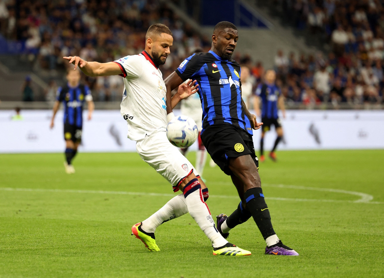 Soccer Football - Serie A - Inter Milan v Cagliari - San Siro, Milan, Italy - April 14, 2024 Cagliari's Pantelis Hatzidiakos in action with Inter Milan's Marcus Thuram REUTERS