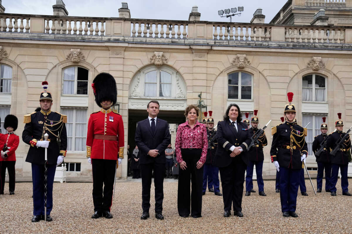 French President Emmanuel Macron and British ambassador to France Menna Rawlings, pose at the Elysee Palace,  Monday, April 8, 2024 in Paris. Sixteen soldiers from No 7 Company Coldstream Guards and 32 members of the Gendarmerie Garde Republicaine mount guard at the Elysee palace as British troops join French guards in a special ceremony at the Elysee Palace to celebrate 120 years of "entente cordiale" between the longtime rival powers.     Thibault Camus