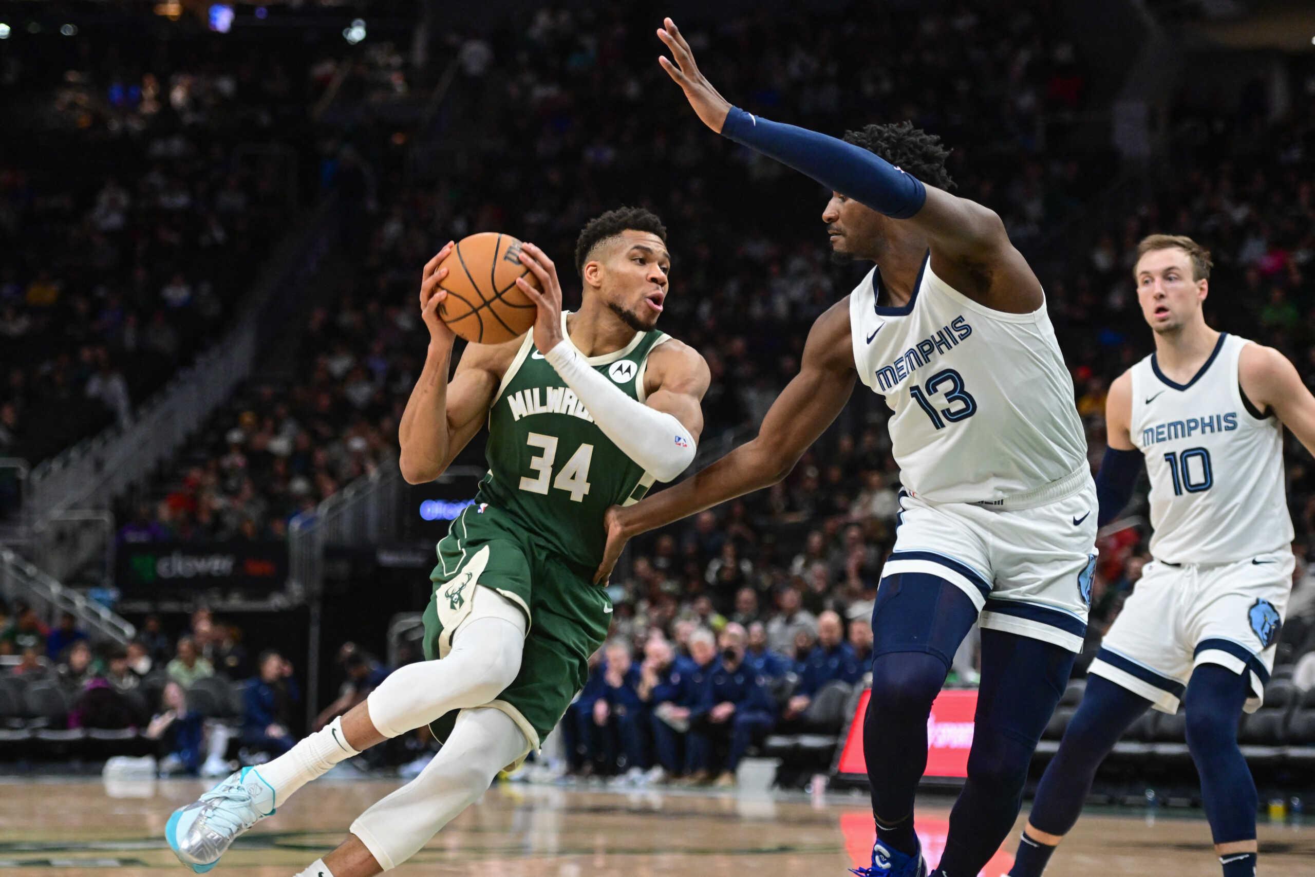 Apr 3, 2024; Milwaukee, Wisconsin, USA; Milwaukee Bucks forward Giannis Antetokounmpo (34) drives for the basket against Memphis Grizzlies forward Jaren Jackson Jr. (13) in the third quarter at Fiserv Forum. Mandatory Credit: Benny Sieu-USA TODAY Sports