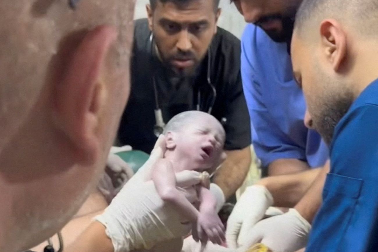 A medic holds a Palestinian newborn girl after she was pulled alive from the womb of her mother Sabreen Al-Sheikh (Al-Sakani), who was killed in an Israeli strike, along with her husband Shokri and her daughter Malak, amid the ongoing conflict between Israel and the Palestinian Islamist group Hamas, at a hospital in Rafah in the southern Gaza Strip, in this still image taken from a video recorded April 20, 2024. Reuters TV via REUTERS     TPX IMAGES OF THE DAY