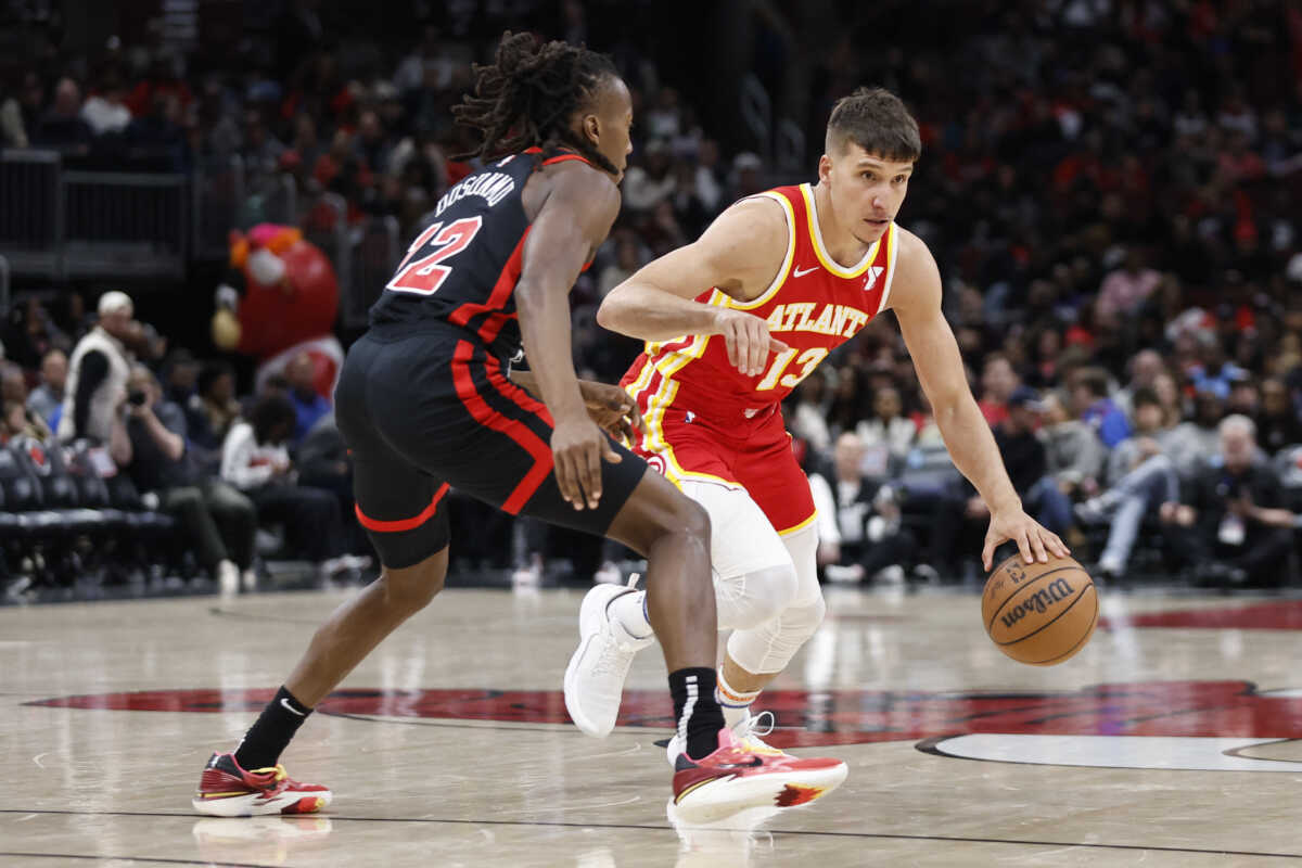 Apr 1, 2024; Chicago, Illinois, USA; Atlanta Hawks guard Bogdan Bogdanovic (13) drives to the basket against Chicago Bulls guard Ayo Dosunmu (12) during the second half at United Center. Mandatory Credit: Kamil Krzaczynski-USA TODAY Sports