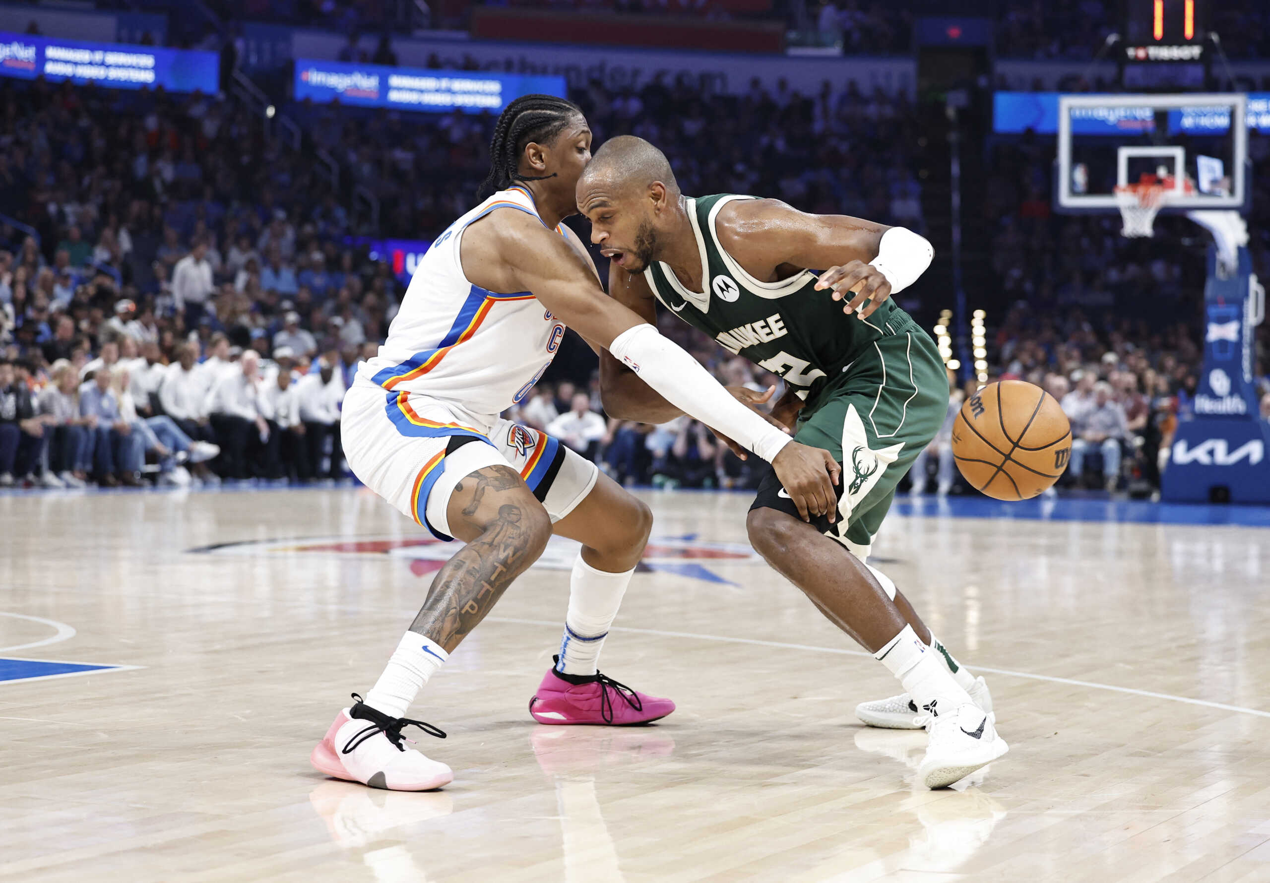 Apr 12, 2024; Oklahoma City, Oklahoma, USA; Oklahoma City Thunder forward Jalen Williams (8) causes Milwaukee Bucks forward Khris Middleton (22) to lose control of the ball during the second quarter at Paycom Center. Mandatory Credit: Alonzo Adams-USA TODAY Sports