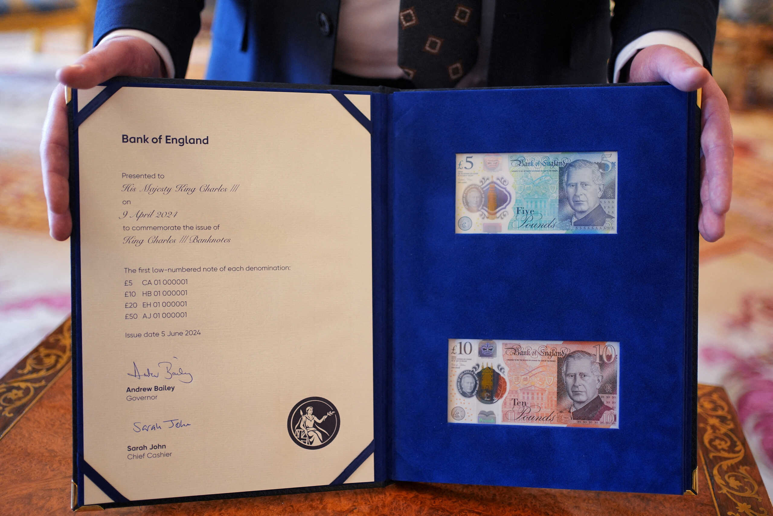 A view of the 5 pounds and 10 pounds banknotes bearing a portrait of King Charles, which will enter circulation on June 5, presented to the King by the Bank of England Governor Andrew Bailey at Buckingham Palace, London, Britain April 9, 2024. Yui Mok