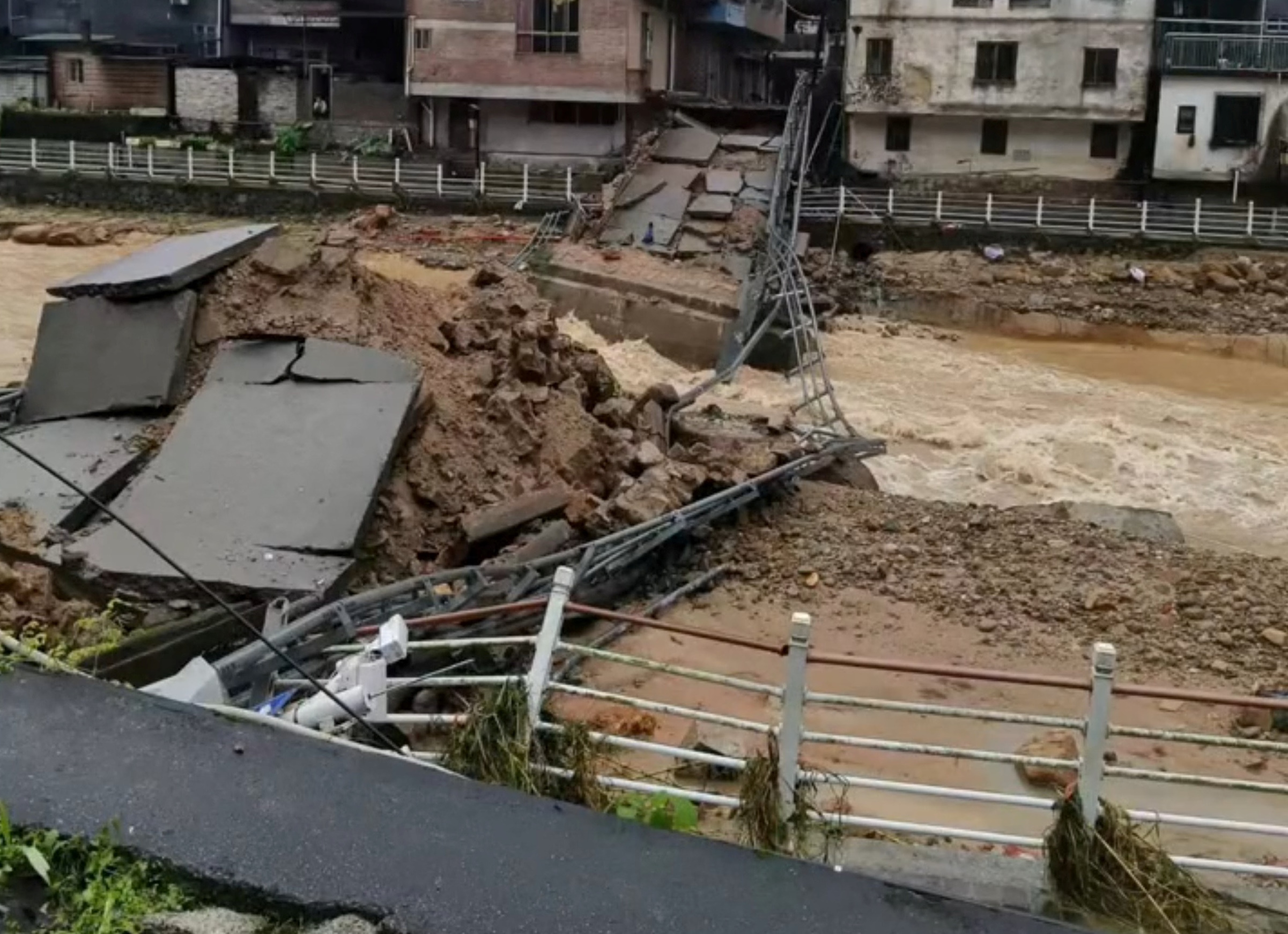 A view of a bridge that collapsed amid heavy rains, in Xiaosanjiang town, Guangdong, China in this screen grab obtained from a social media video released April 21, 2024. Video Obtained By Reuters
