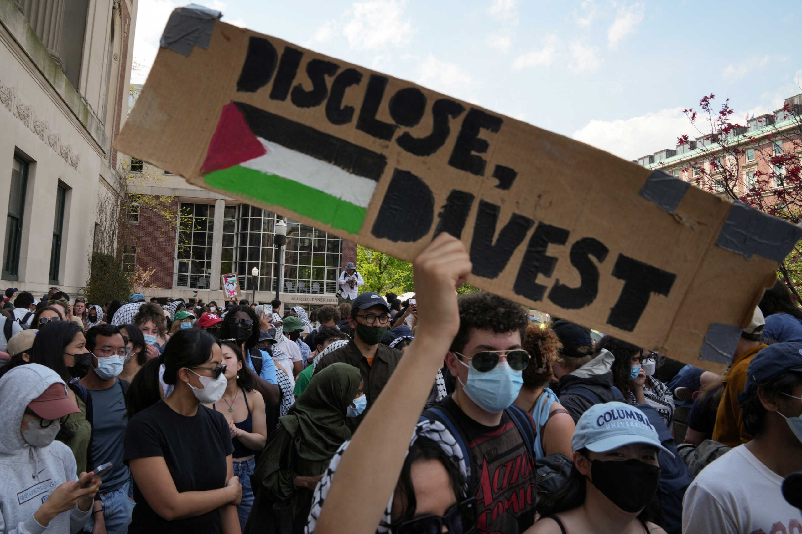 A protester holds a sign during a march on Columbia University campus in support of a protest encampment supporting Palestinians, despite a 2 pm deadline issued by university officials to disband or face suspension, during the ongoing conflict between Israel and the Palestinian Islamist group Hamas, in New York City, U.S., April 29, 2024. REUTERS