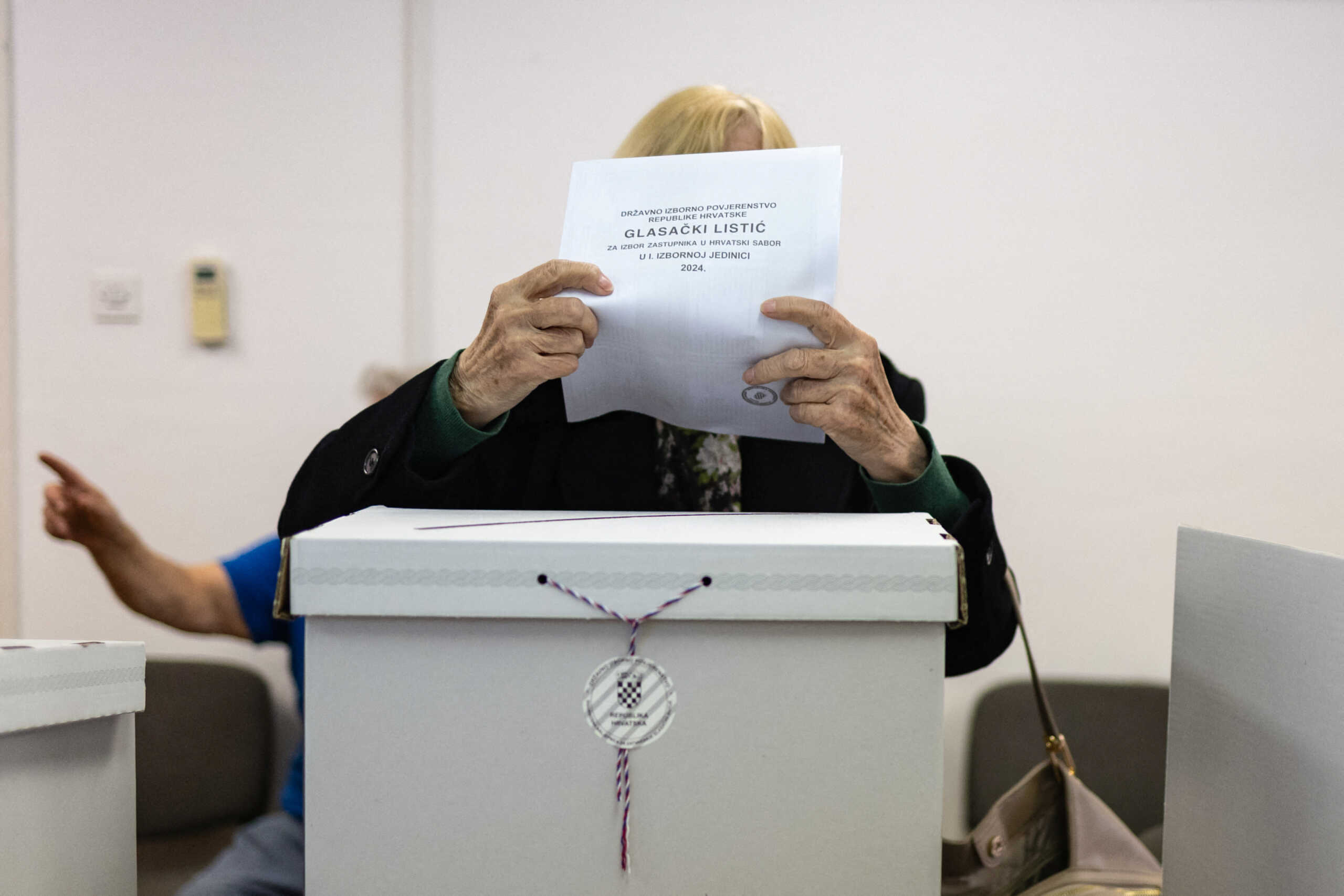 A woman votes in the parliamentary election at a polling station in Zagreb, Croatia, April 17, 2024. REUTERS