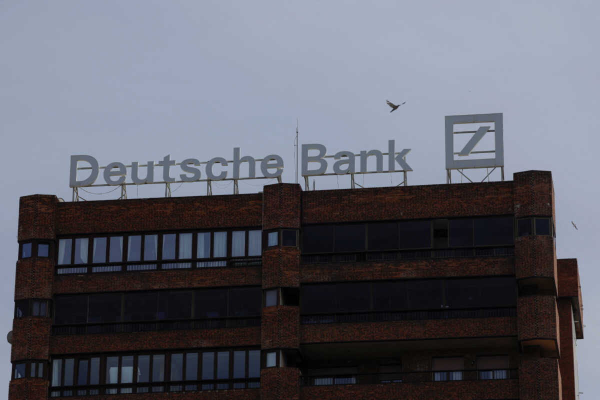 The logo of Deutsche Bank is seen on the roof of a building outside a Deutsche Bank branch office in Malaga, Spain, April 24, 2024. REUTERS